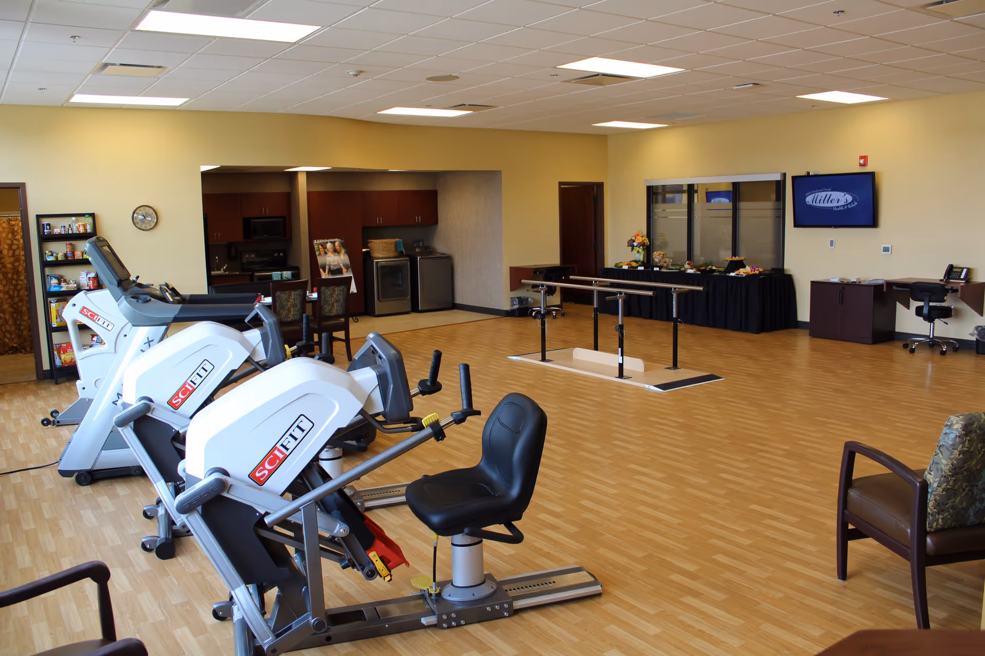 Interior fitness area with treadmills and seating inside Miller's Health and Rehab facility.