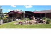 Front exterior of Boulder Canyon Health and Rehabilitation with a landscaped rock garden.