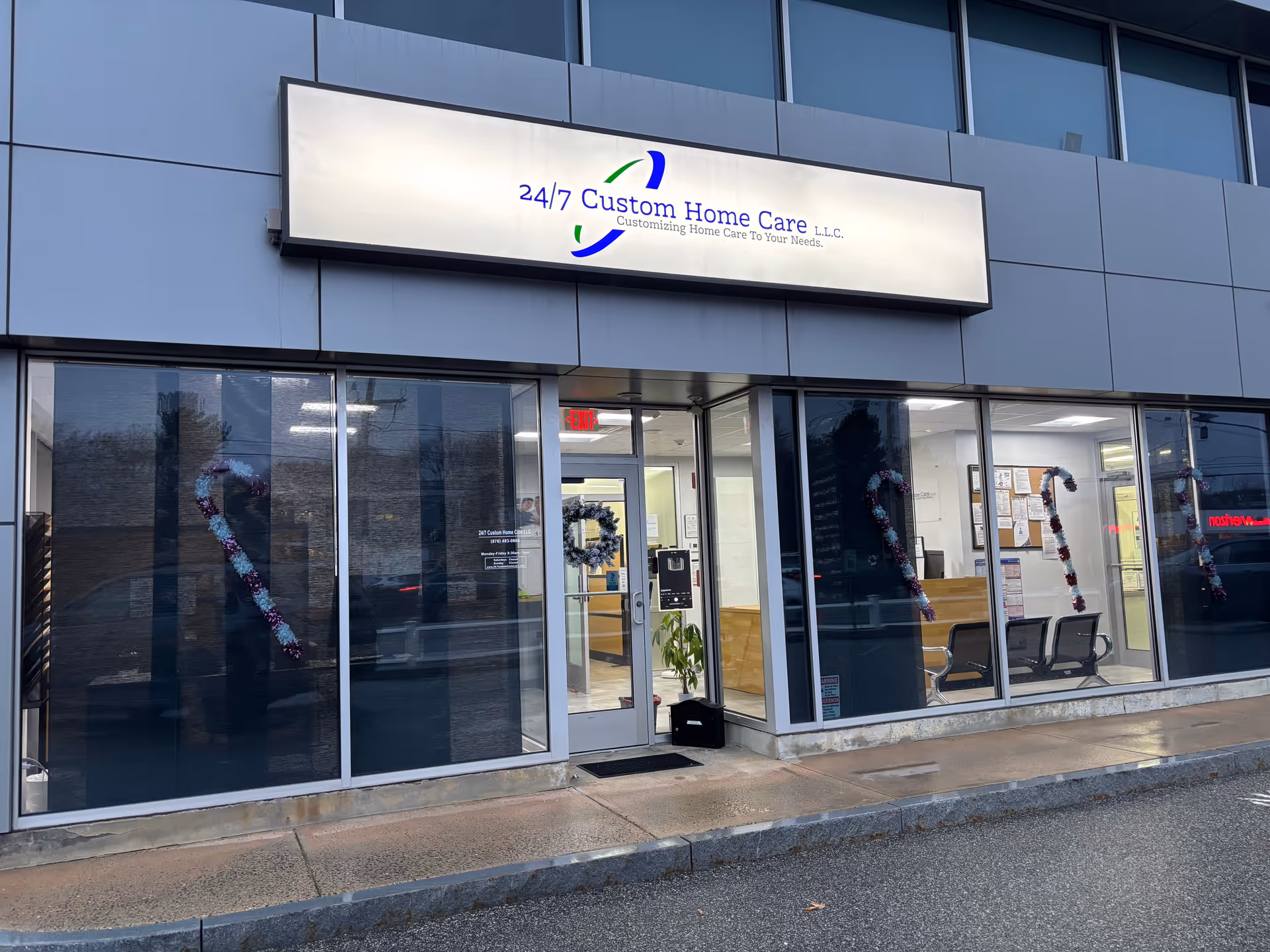 Exterior view of a storefront with 24/7 Custom Home Care LLC signage.
