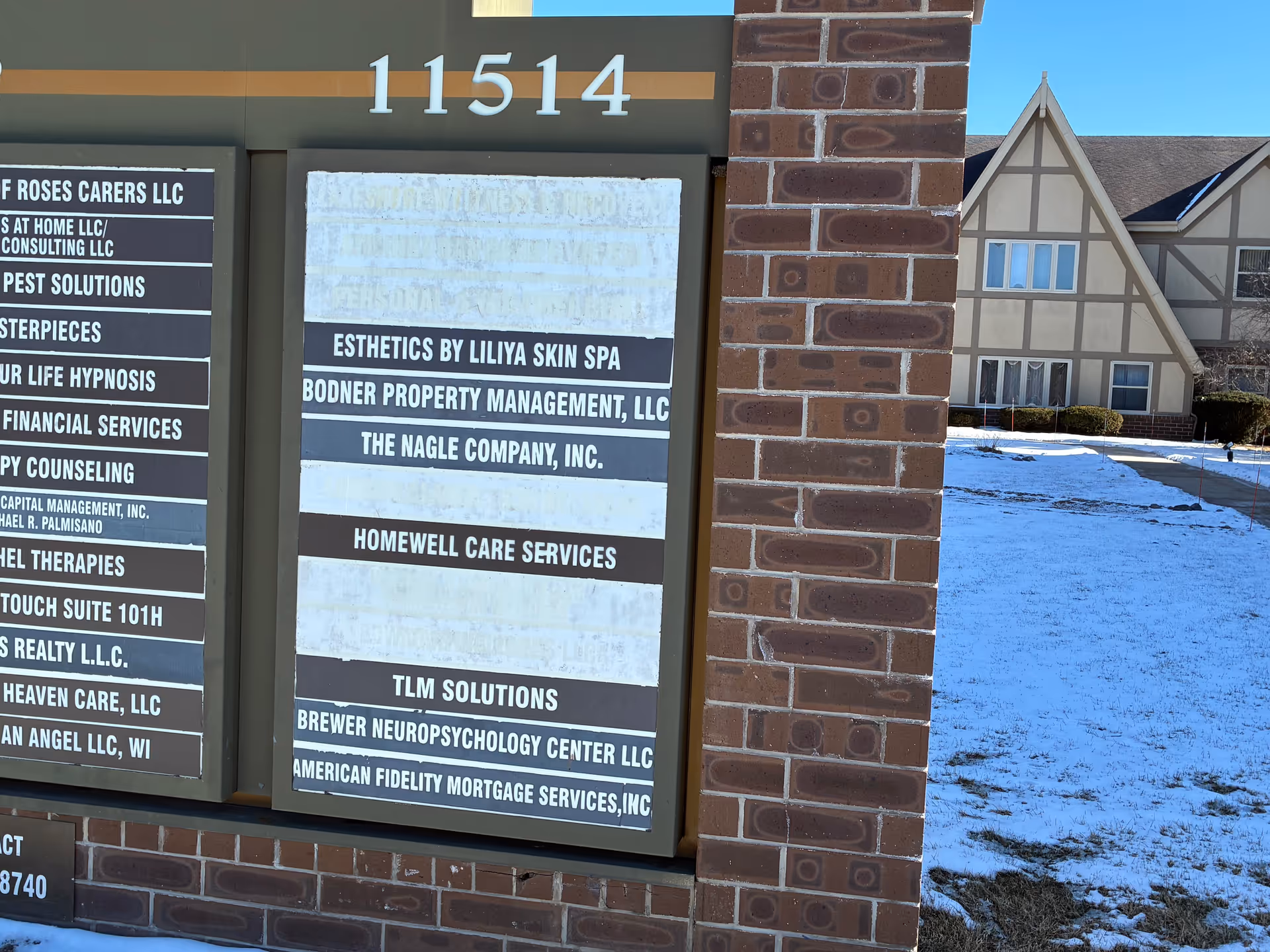 Exterior view of HomeWell Care Services building with brick facade and snow on the ground.