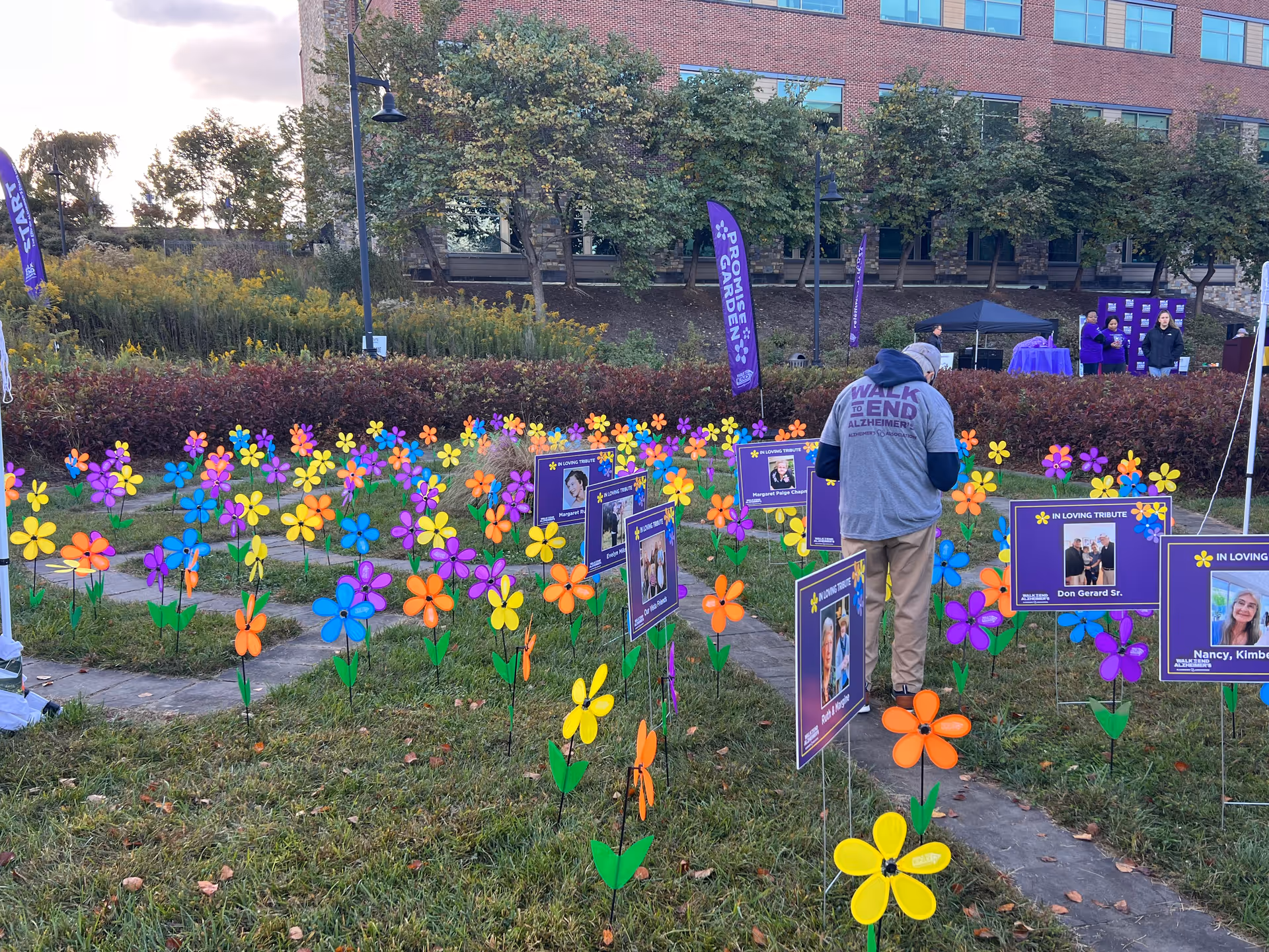 Outdoor garden at Visiting Angels Senior Home Care Charlottesville with colorful pinwheels and signage.
