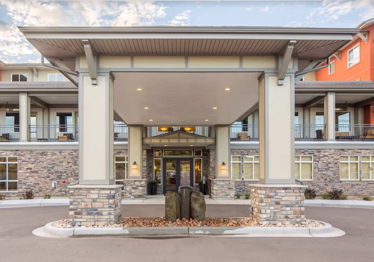 Front entrance of Affinity at Colorado Springs with stone columns and a covered drive.