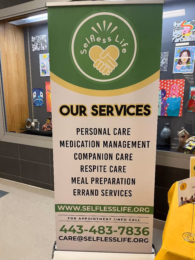Vertical banner in a hallway advertising Selfless Life services and care options.