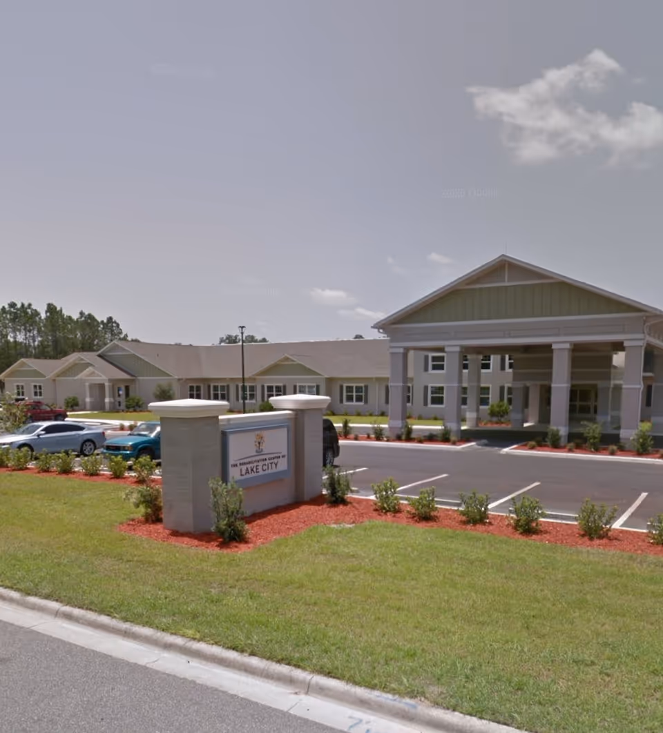 Exterior view of a senior living facility entrance with a porte-cochere.