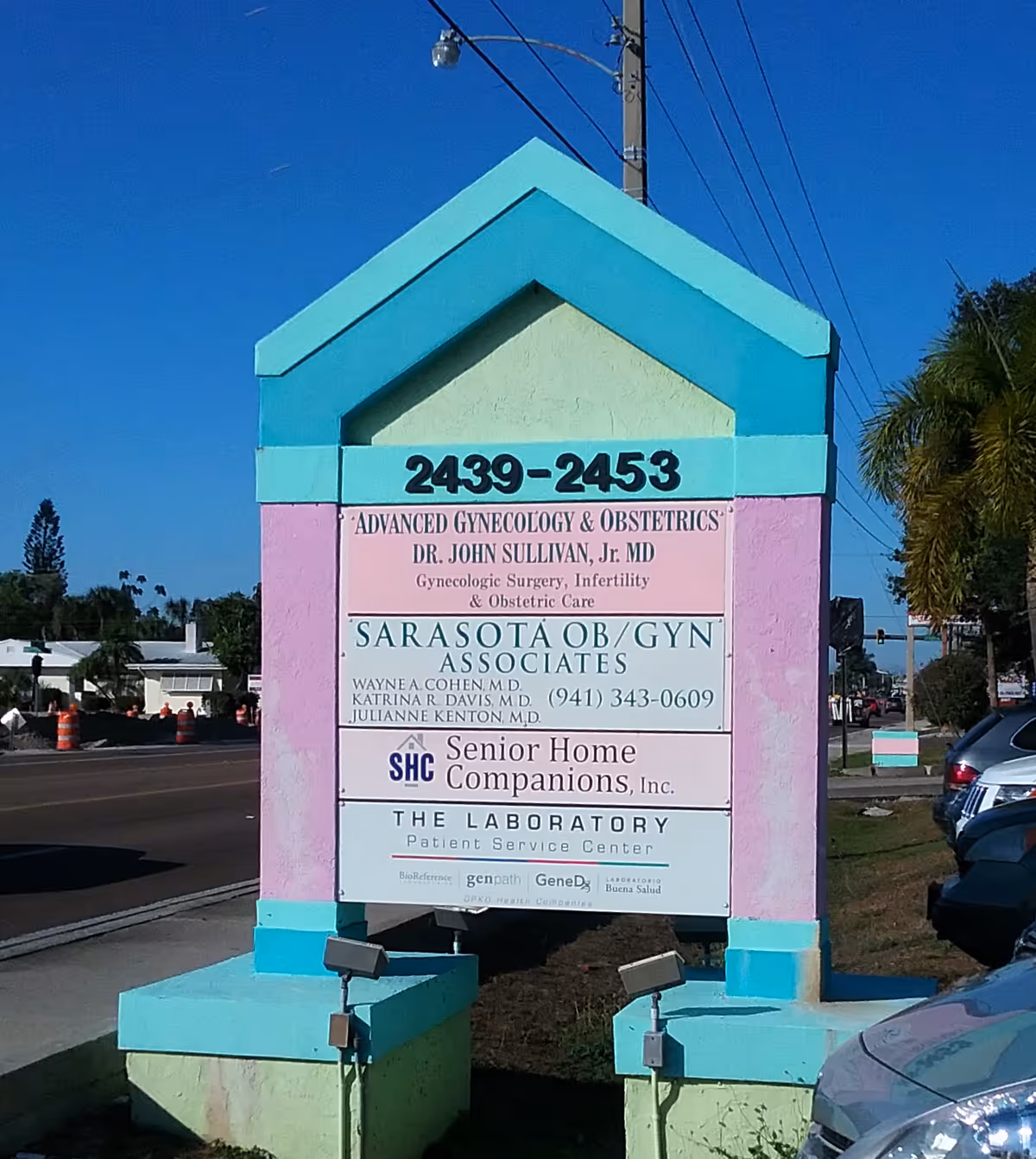 Colorful exterior sign for Senior Home Companions along a street.