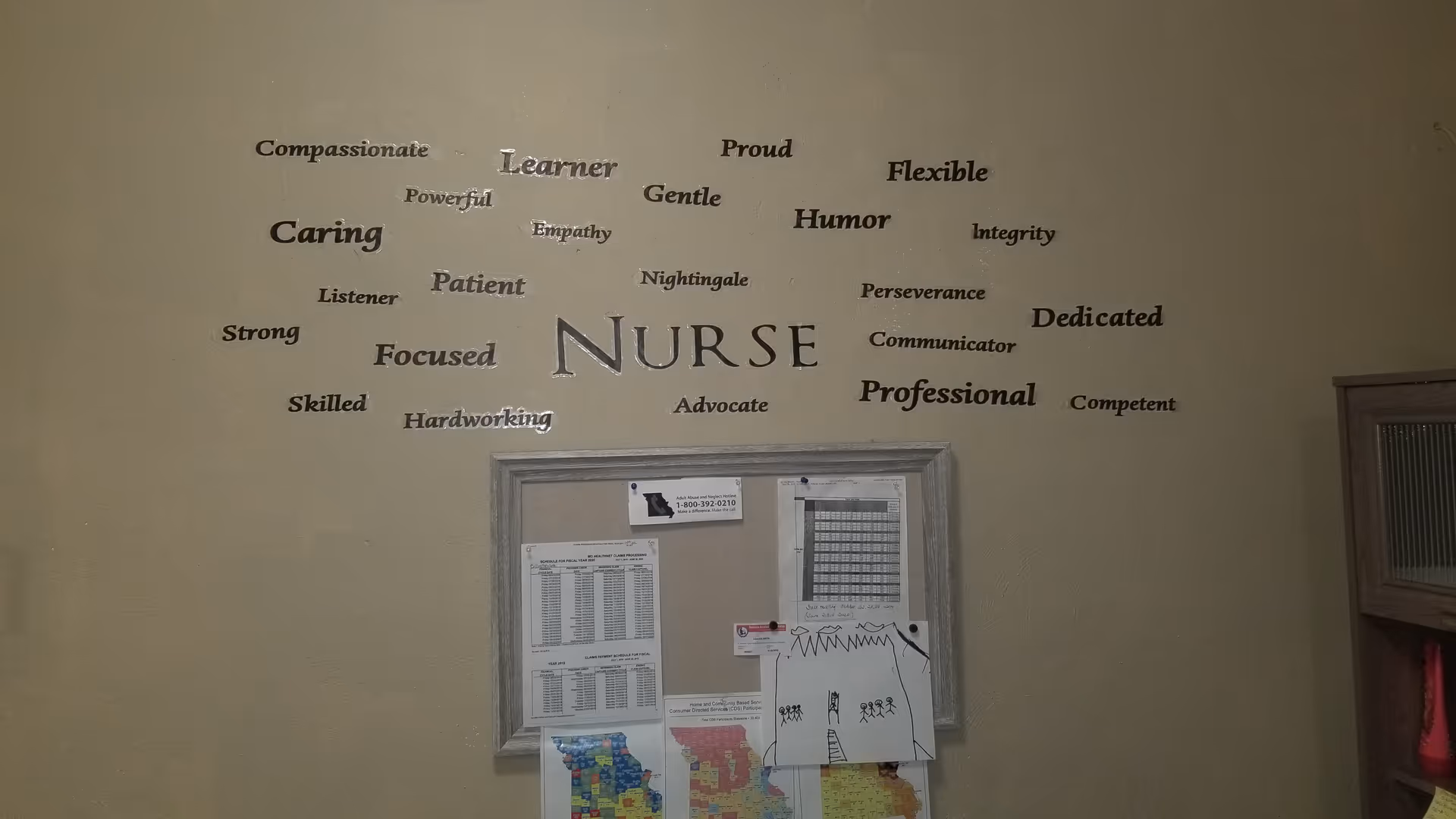 Hallway interior featuring nurse-themed wall graphic and a framed notice board