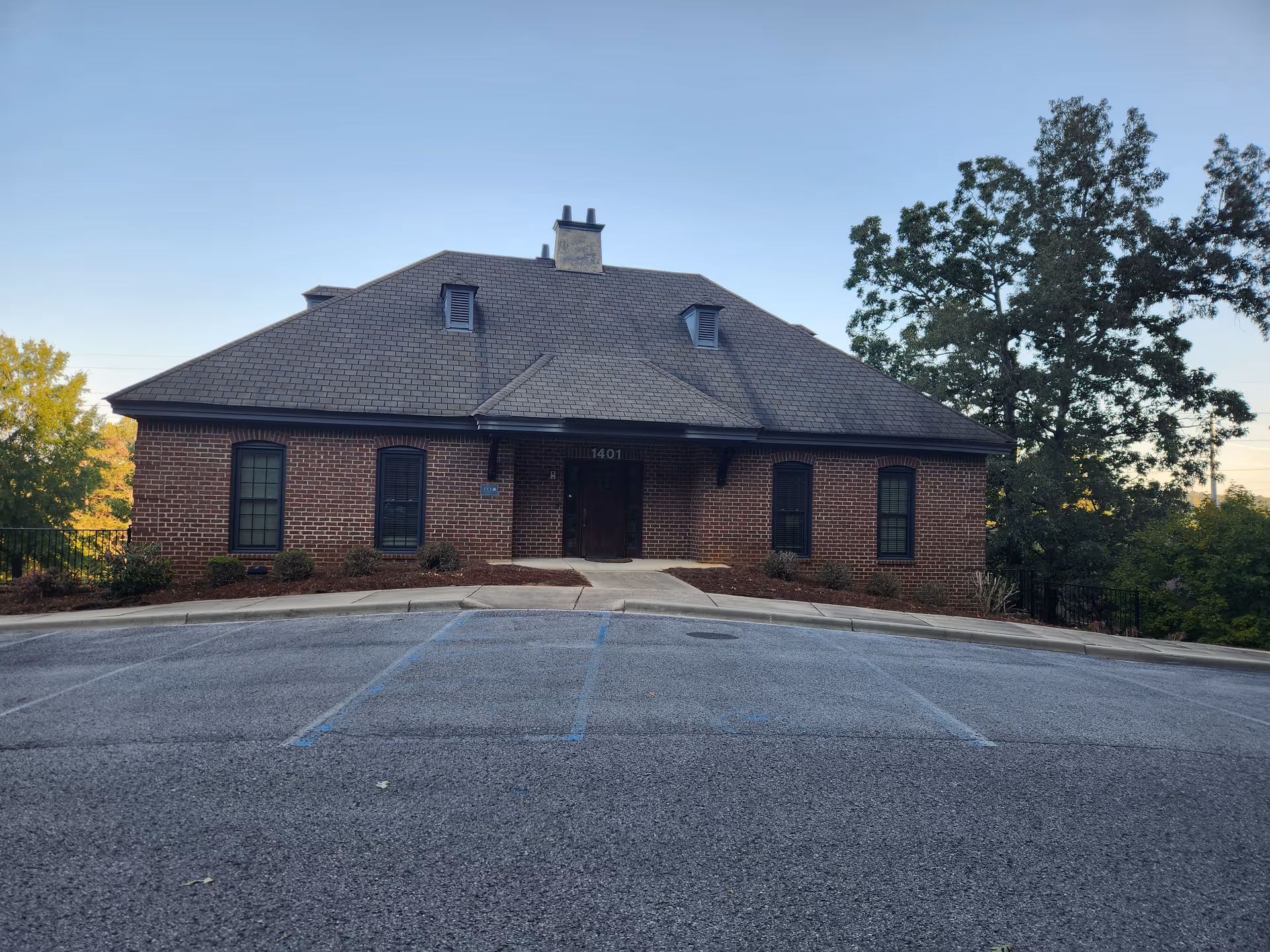 Brick building for Home Helpers Home Care of Hoover with a parking lot.