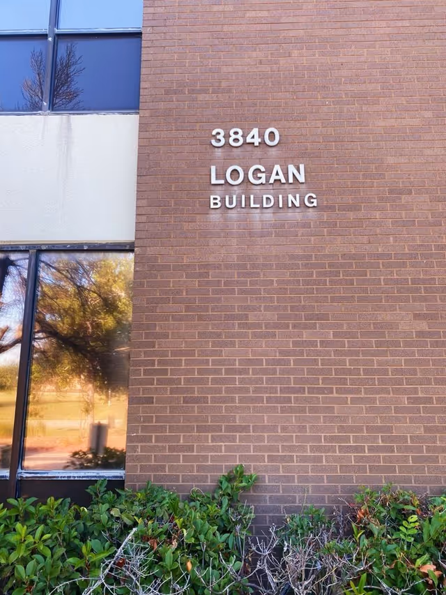 Brick building facade with 3840 LOGAN BUILDING lettering.