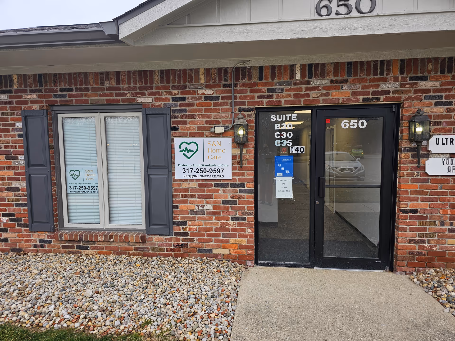 Brick facility entrance with glass doors and S&N Home Care signage.