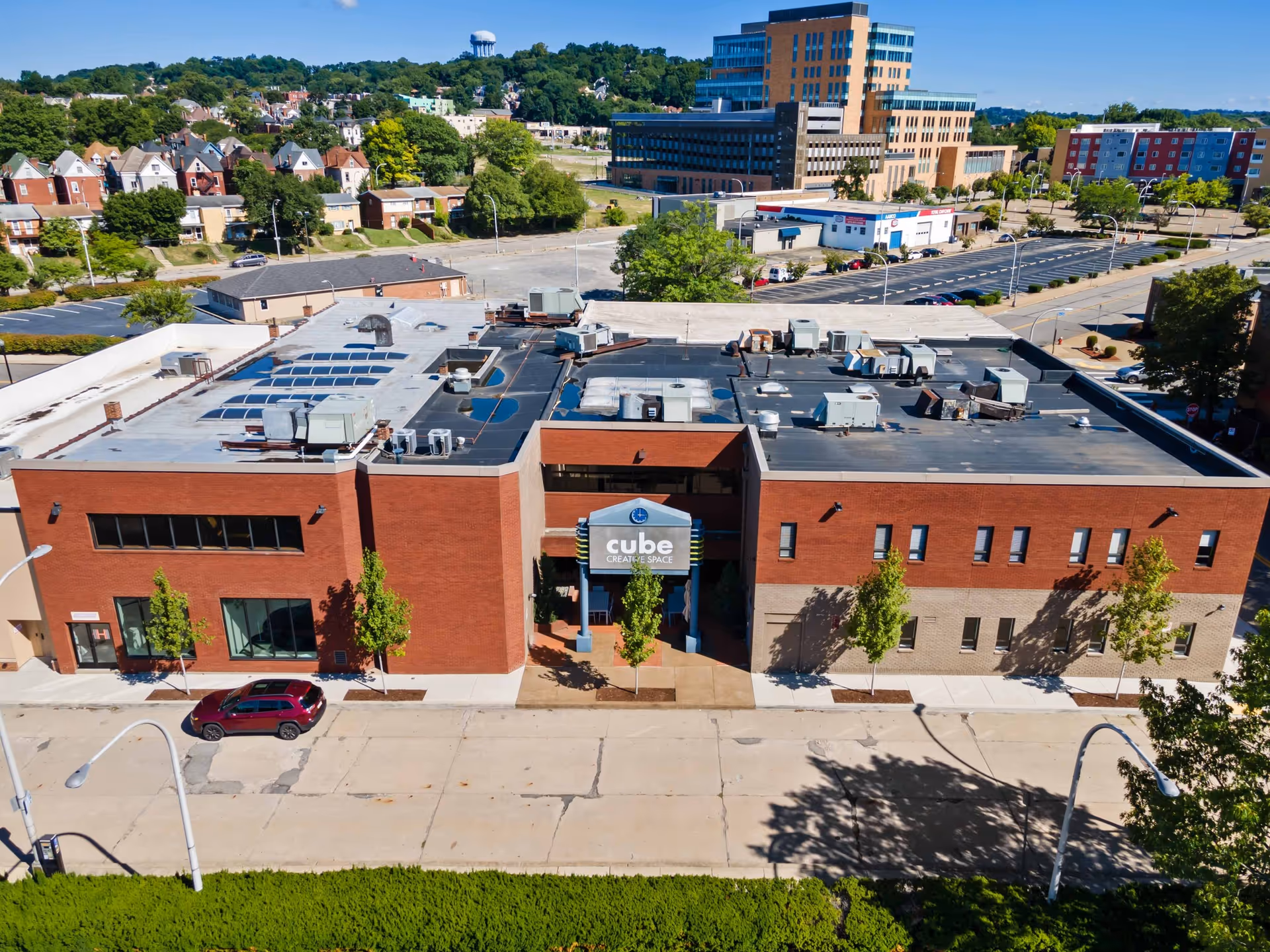 Aerial view of a brick senior living facility building and surrounding urban area.