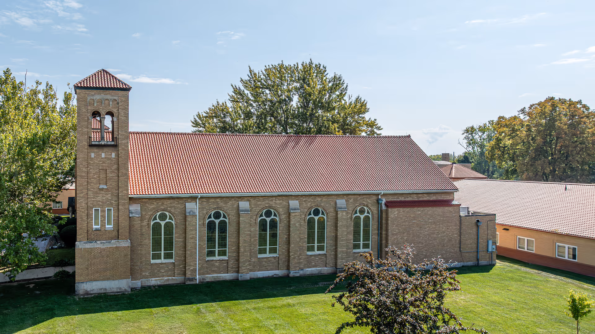 Exterior view of Ascension Saint Joseph Village building with brick facade and bell tower.