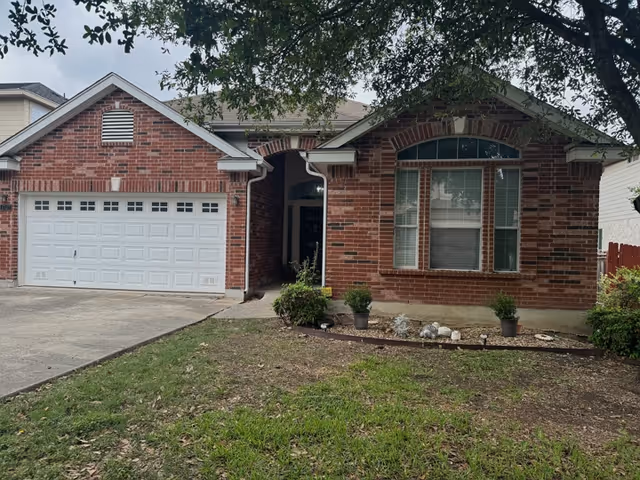 Brick front of Harmony Care Home LLC with attached two-car garage and entry path.