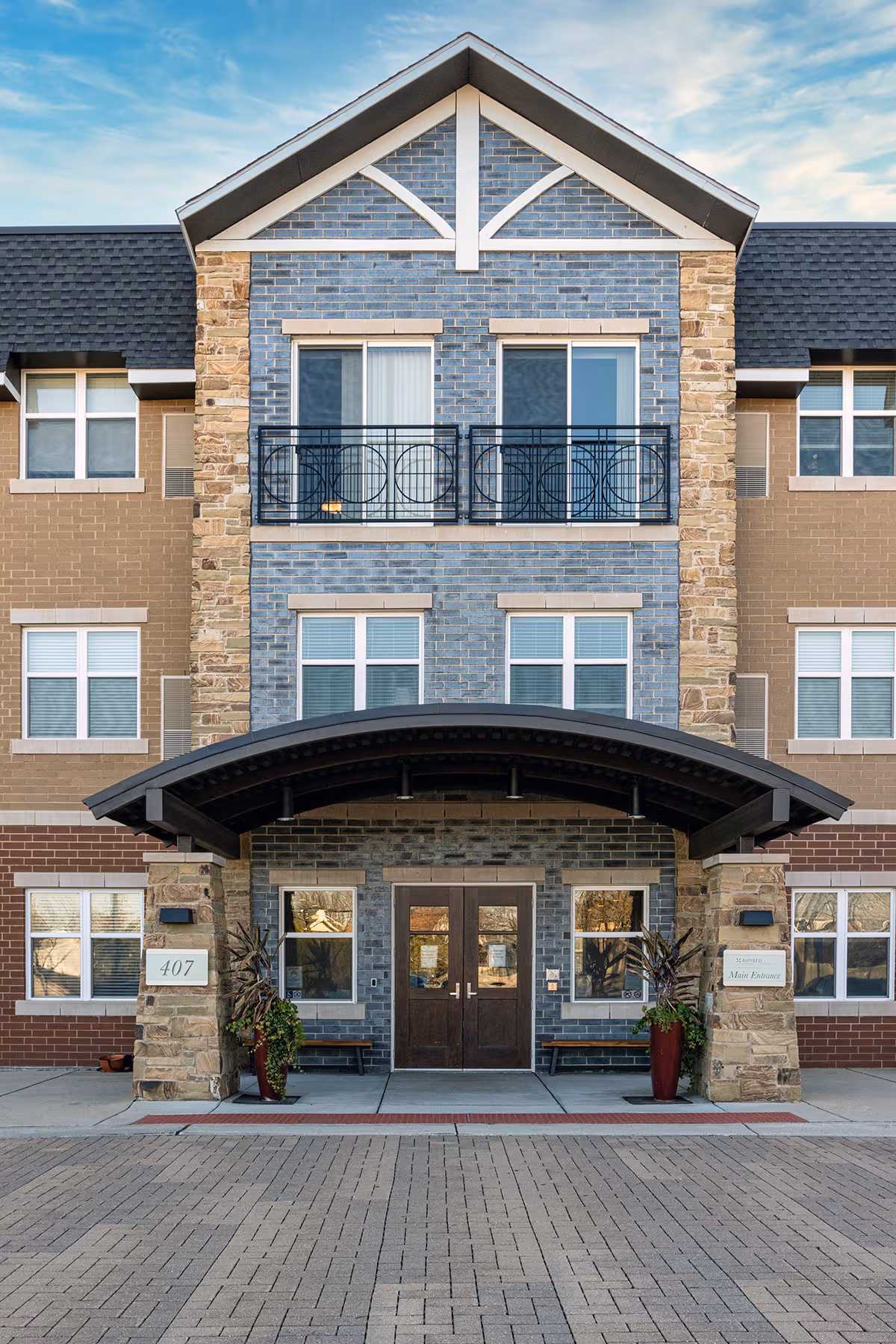 Facade of Sunrise of Westmont showing brick and blue stone entry with double doors.
