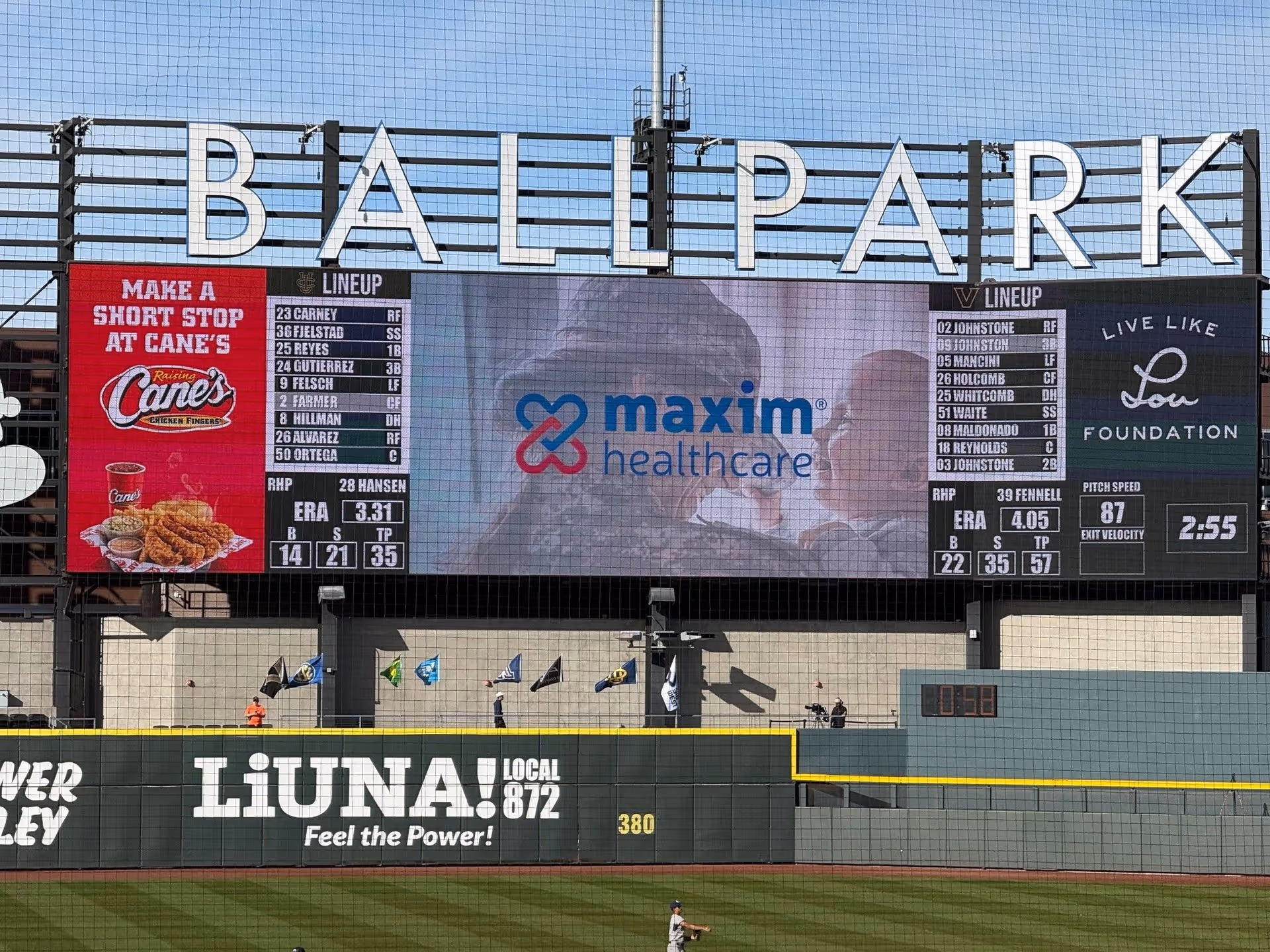 Outdoor baseball stadium scoreboard featuring Maxim Healthcare logo and BALLPARK sign