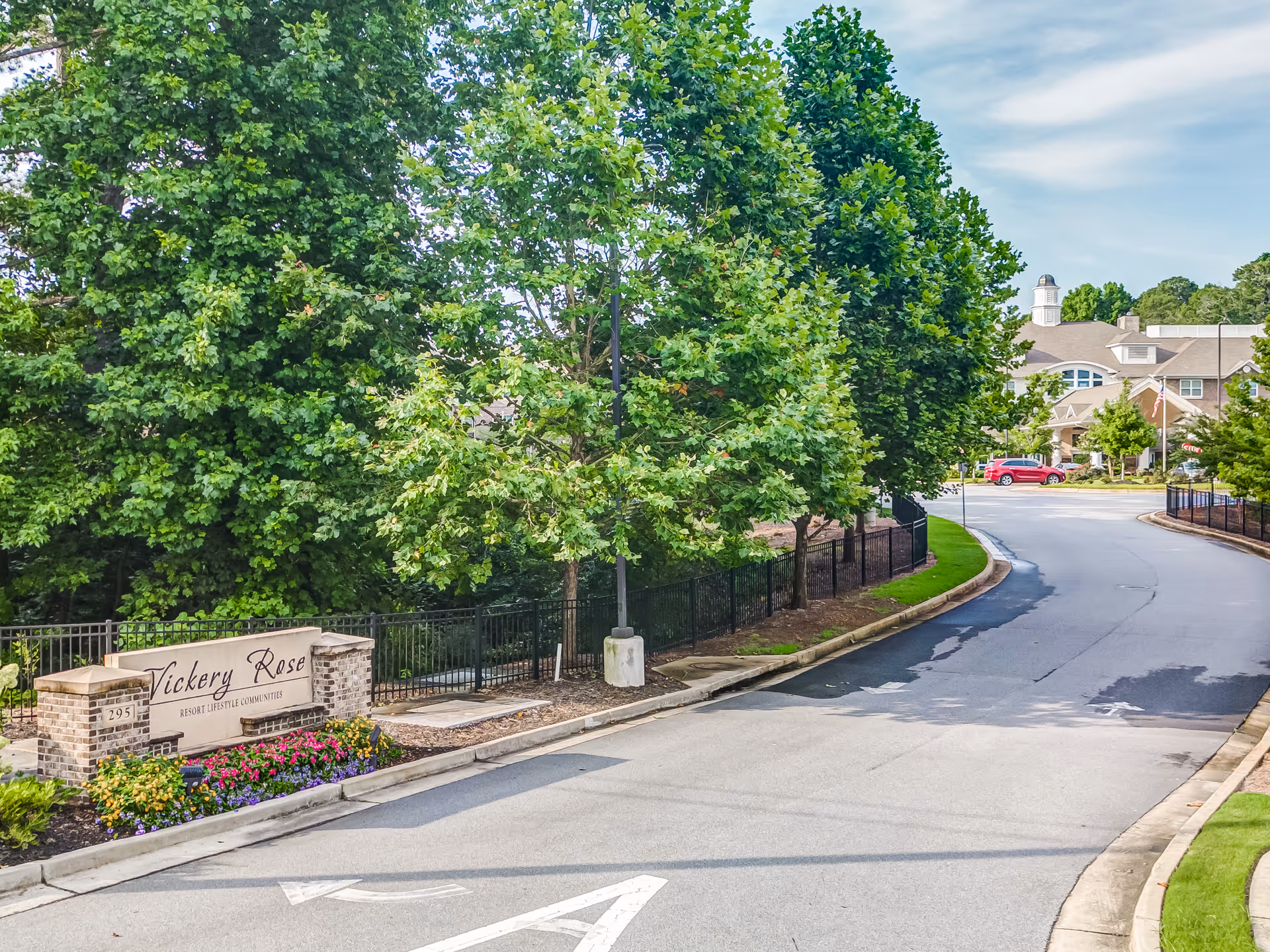 Vickery Rose Retirement Resort entrance along curved road with trees and sign