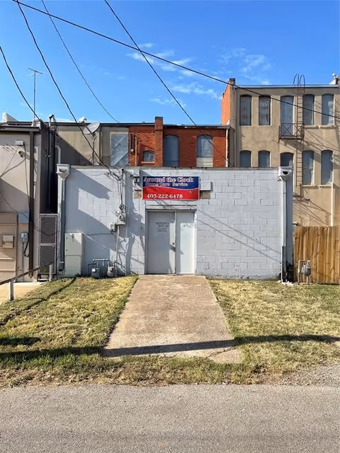 Front view of a small grey building with a sign for Around the Clock Home Care.