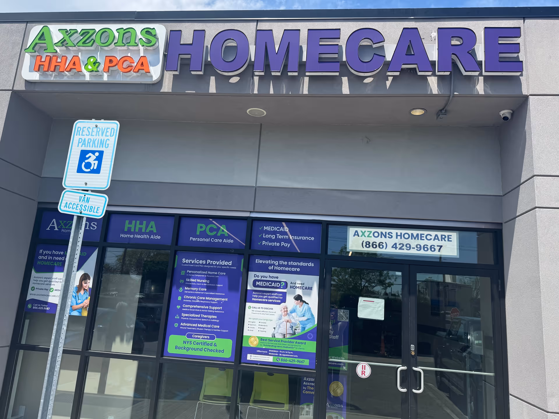 Front exterior of Axzons Homecare storefront in Nassau County with large sign and blue tinted windows.