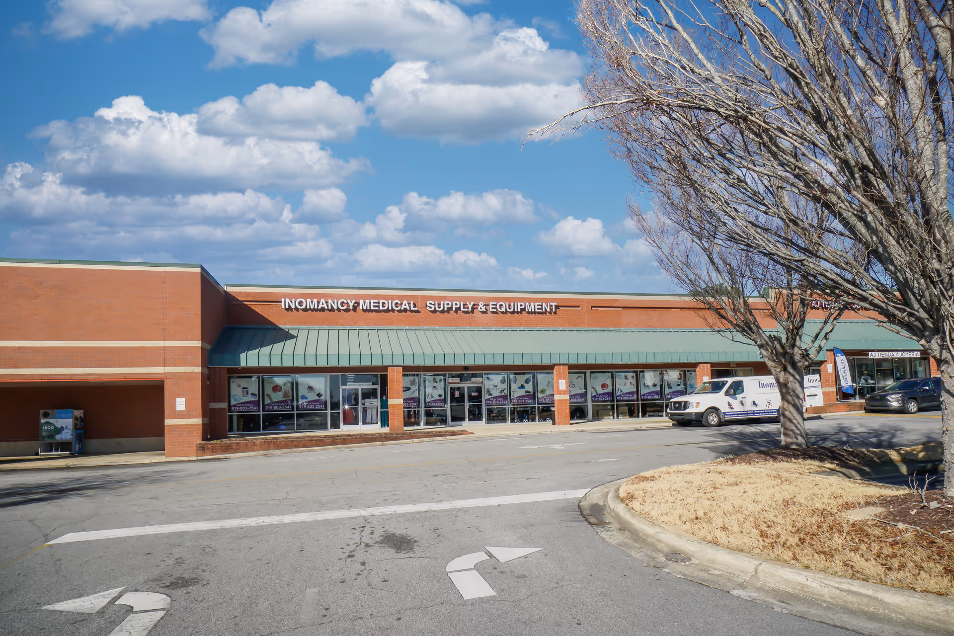 Exterior view of Inomancy Medical Supply storefront at a brick shopping center.