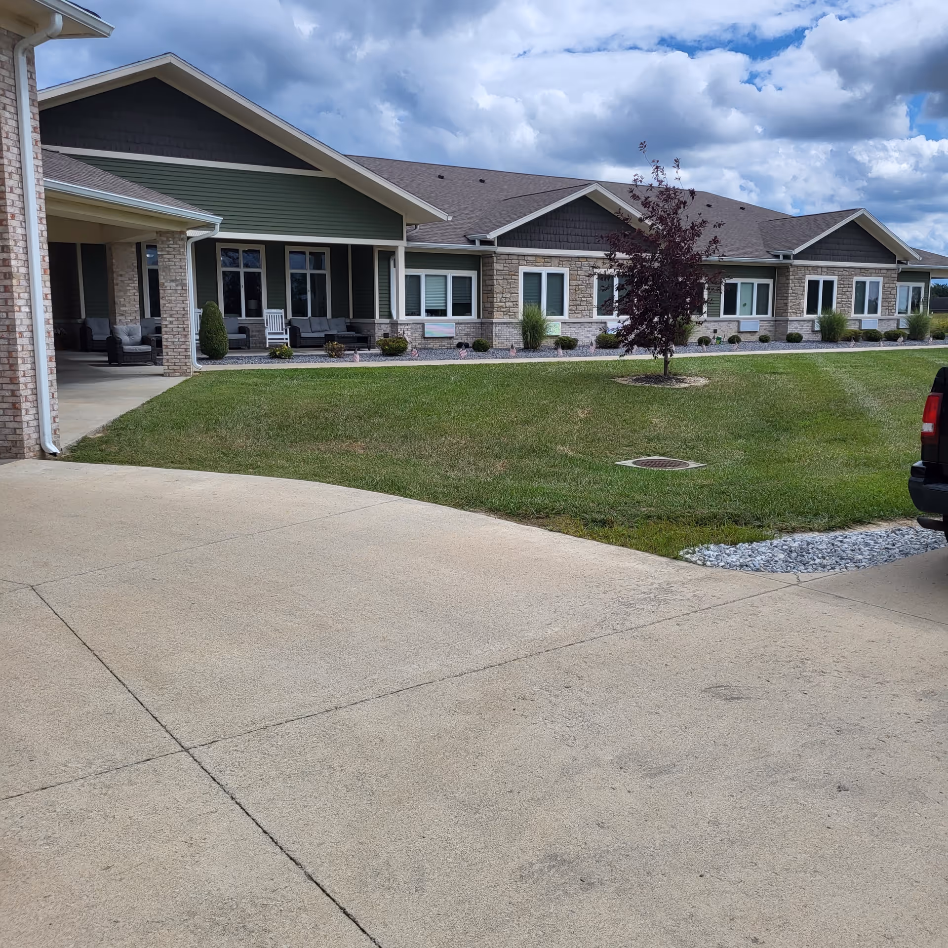 Exterior view of Autumn Trace Senior Communities Greene County, a single-story facility with lawn and driveway.