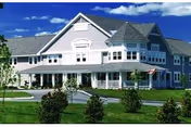 Montello Heights senior living facility exterior with wraparound porch and manicured lawn.