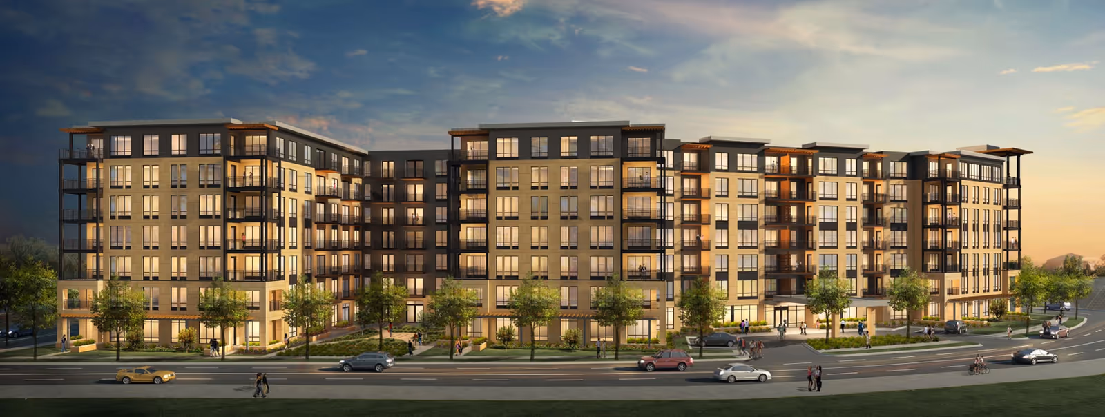 A modern, multi-wing senior living building with balconies and trees along a street at dusk.