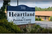 Outdoor front-sign for Heartland of Preston County in front of a building.