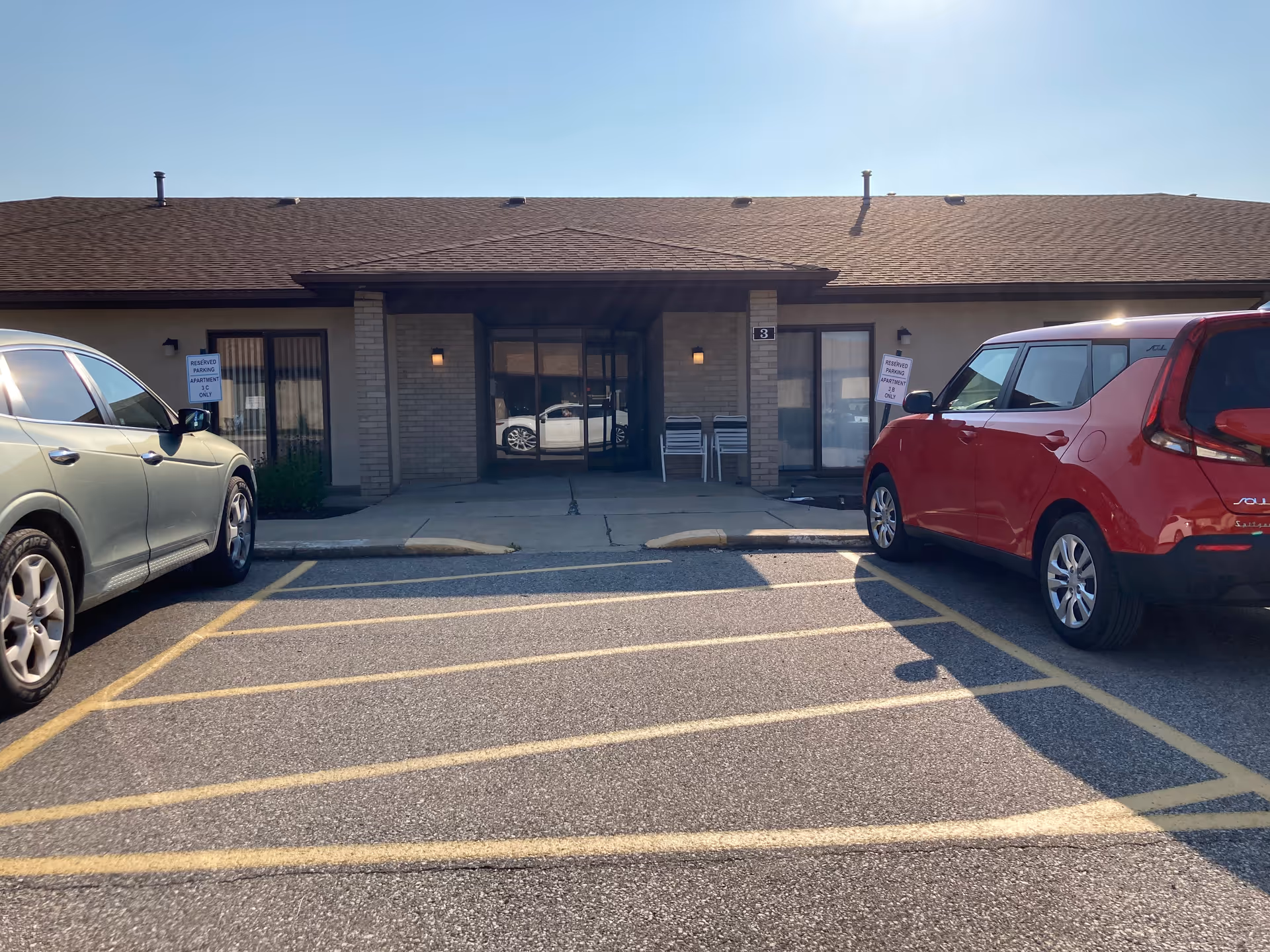 Front view of North Park Care Center with parked cars and glass entrance.