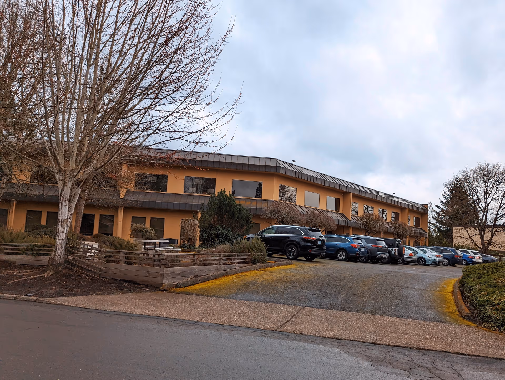Exterior view of Comfort Keepers facility in Portland with parked cars.