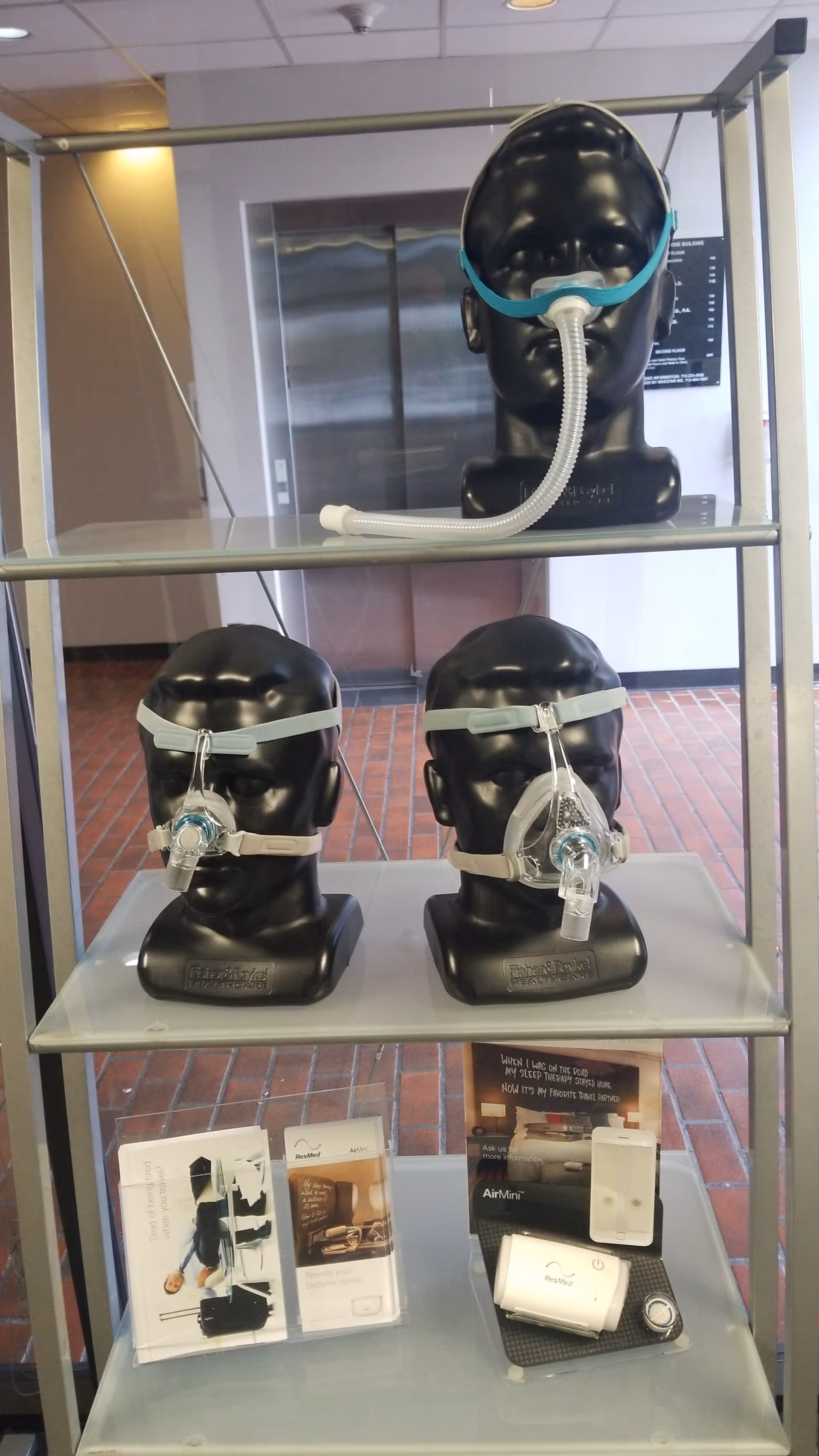 Metal shelving displays CPAP masks and sleep apnea equipment inside a facility lobby.