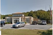 Exterior view of Countryside Health Care of Milford with a parking lot.