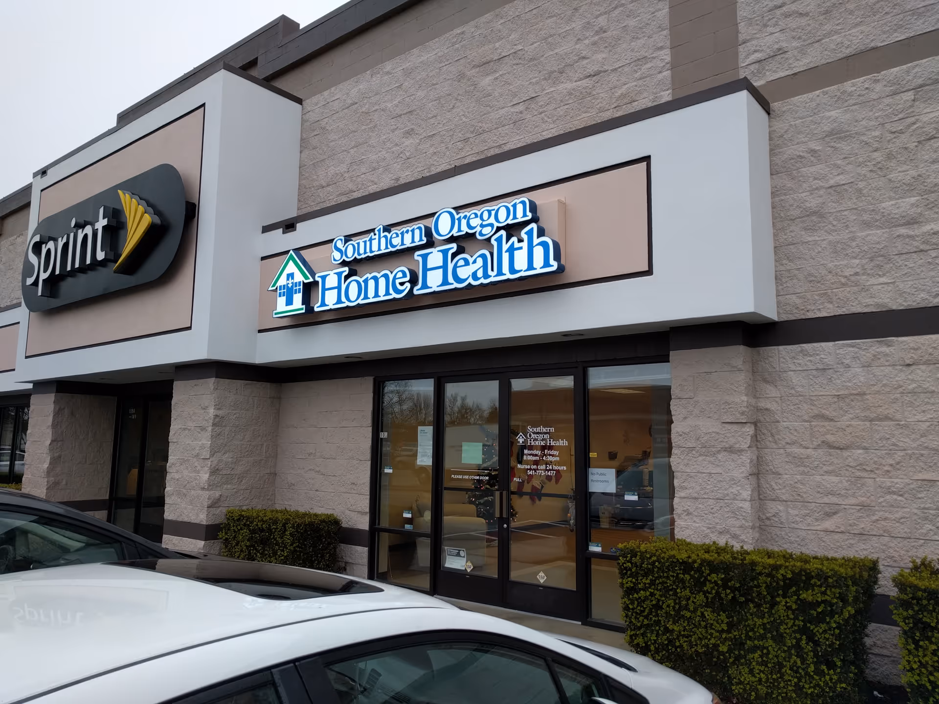 Exterior storefront with Sprint and Southern Oregon Home Health signage on the building front