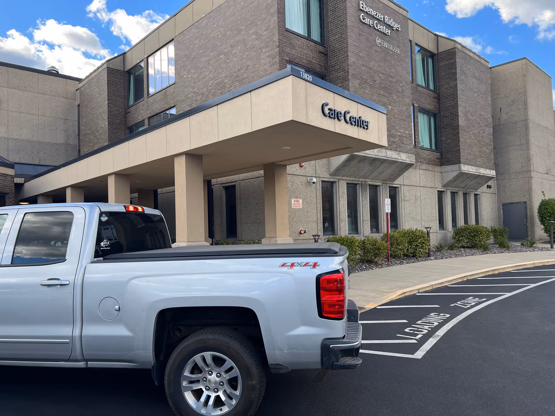 Exterior view of Ebenezer Ridges Campus entrance with a silver pickup.