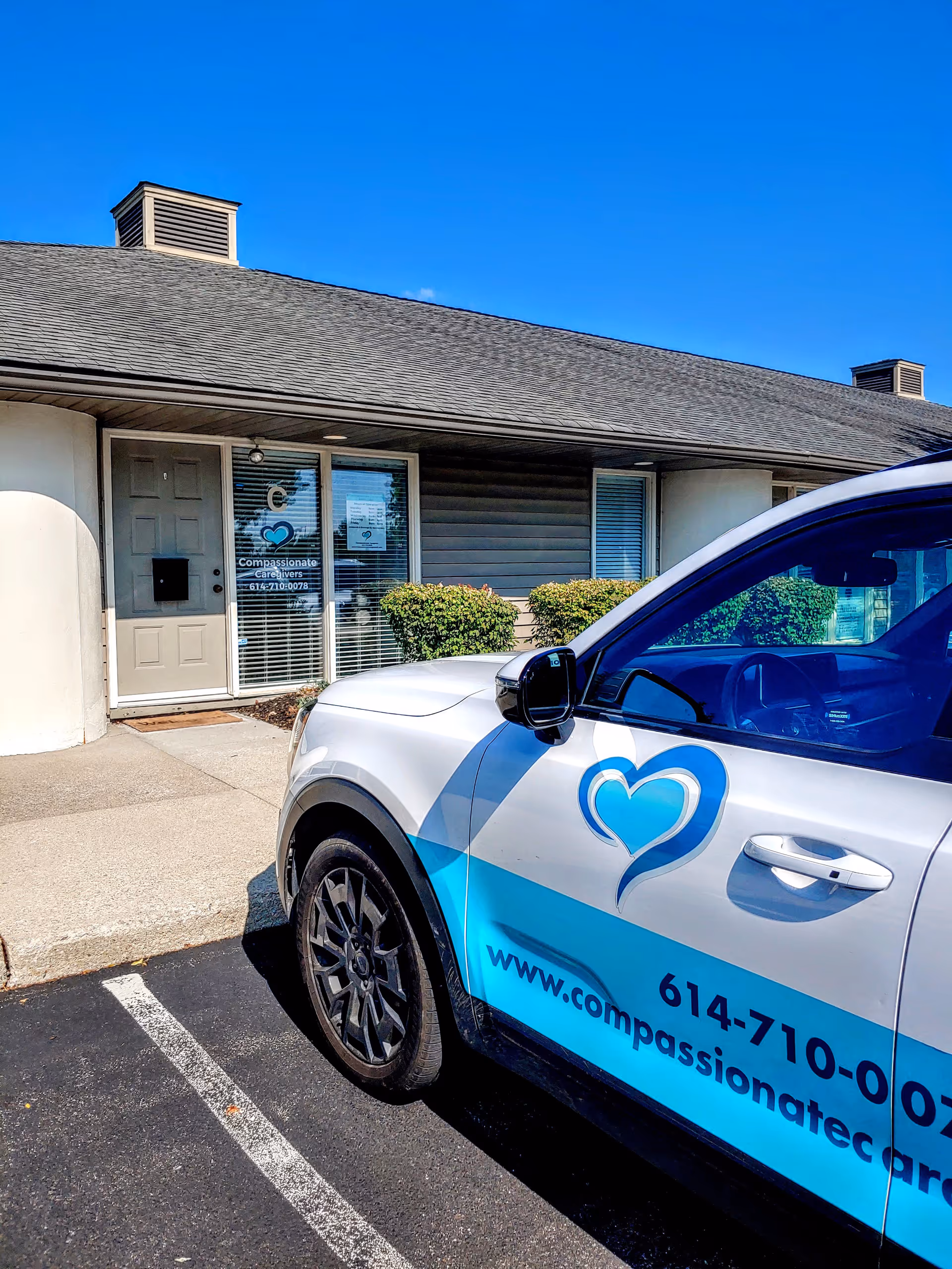 Front exterior of Compassionate Caregivers Home Care building with a branded vehicle parked.