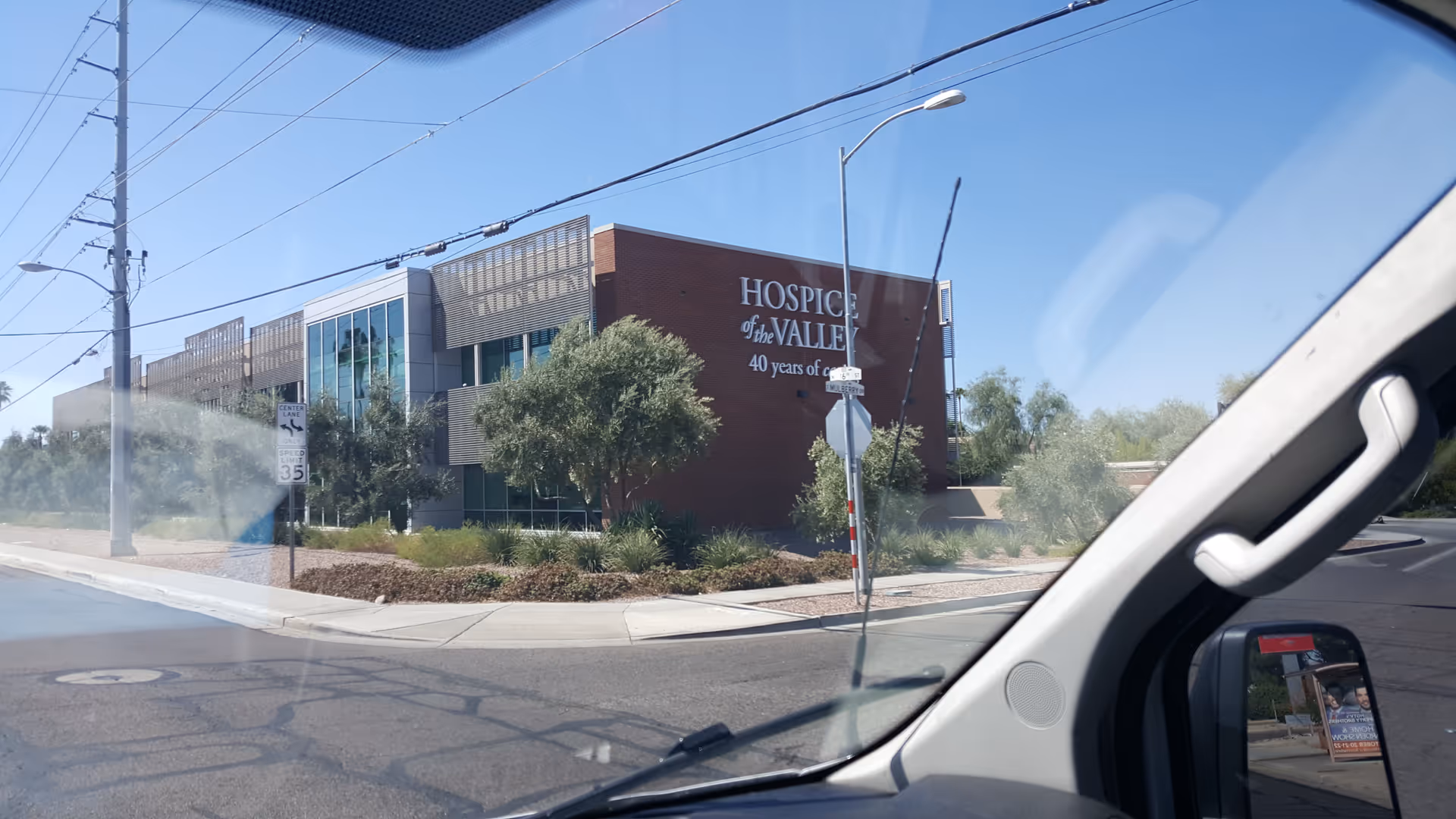 Exterior view of Hospice of the Valley building with landscaping and a street backdrop.