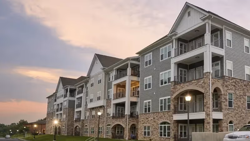 Exterior of EverTrue Luther Crest senior living building with balconies and stone accents.