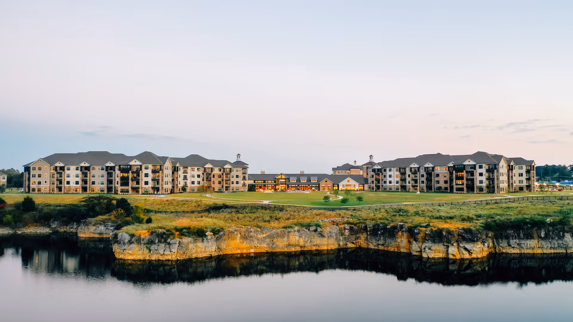 Health Services at the Spires complex sits along a cliffside waterfront with multiple beige buildings.