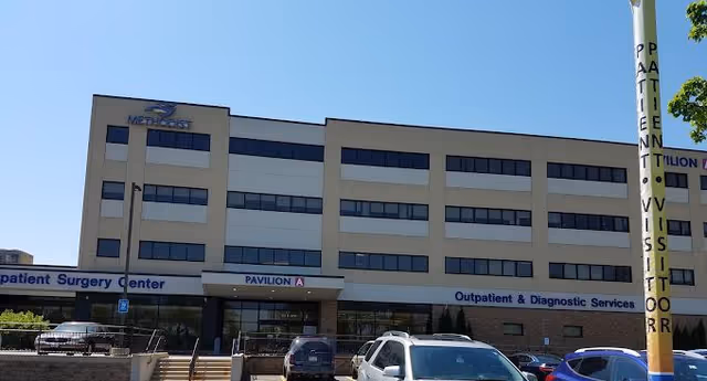 Exterior view of Methodist Hospitals Rehab Center building with parking lot and blue sky