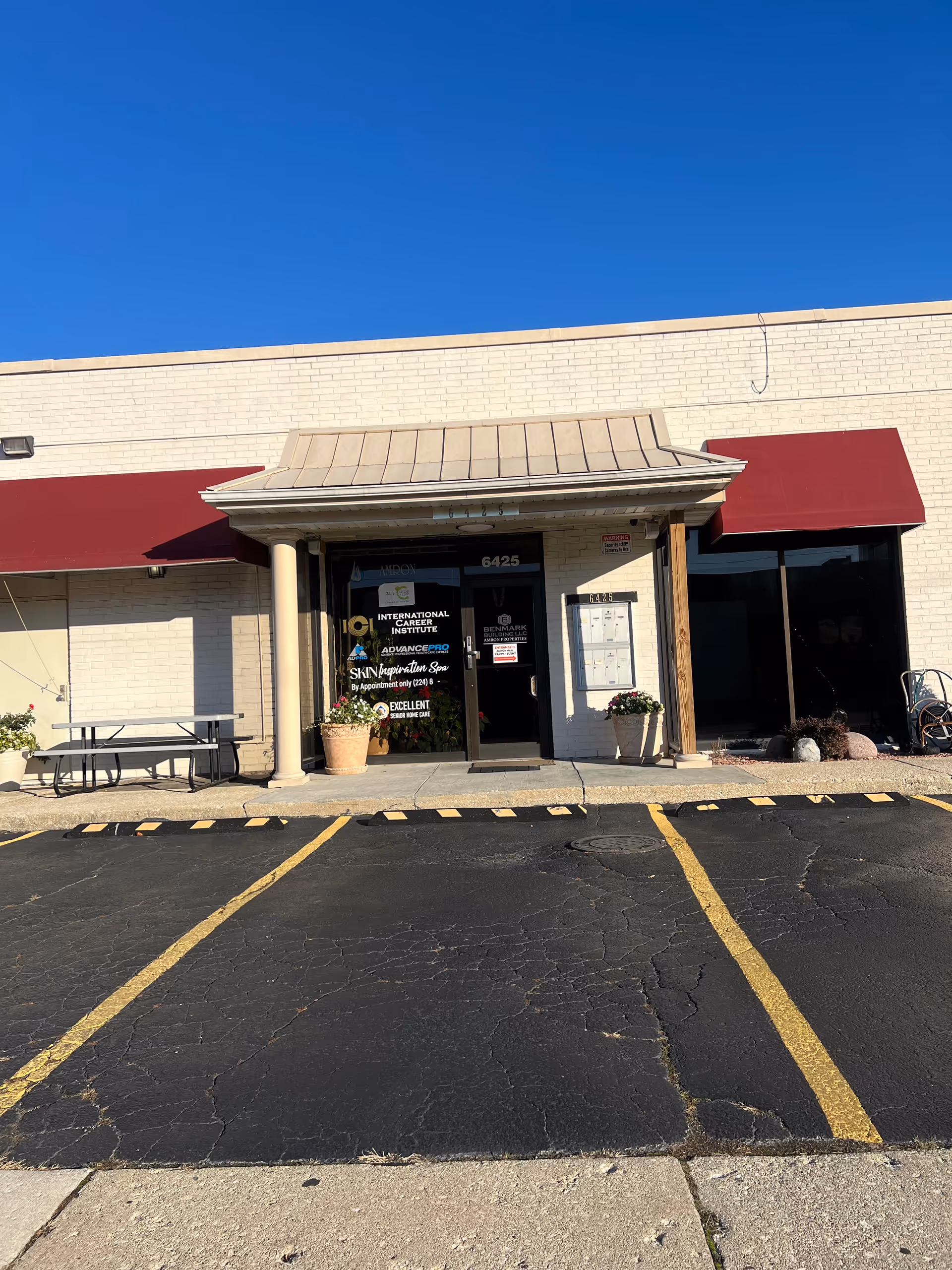 Exterior view of Healthychoice Home Health building with a storefront entrance and red awnings.
