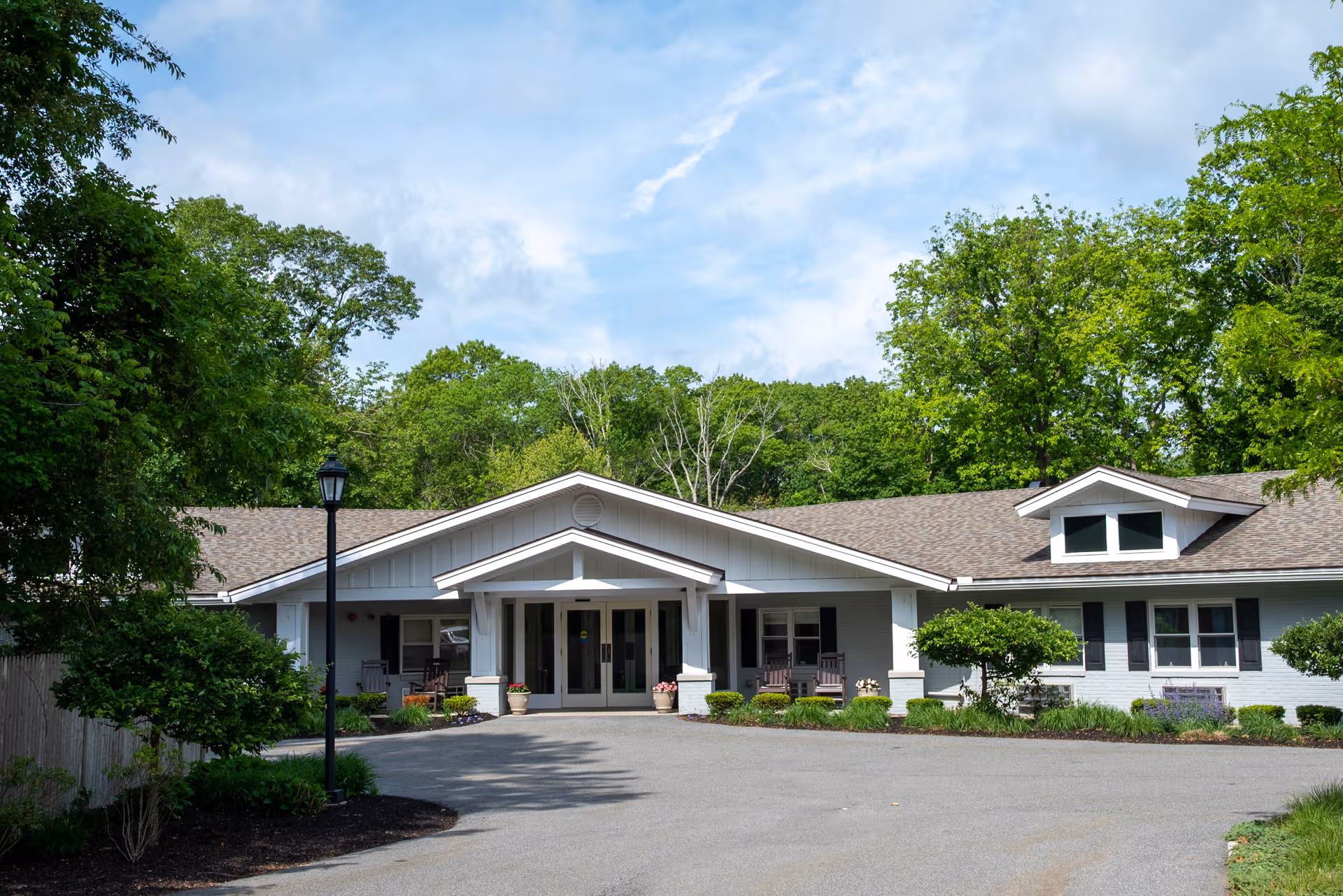 Exterior view of a single-story facility with a central entrance and lush landscaping.