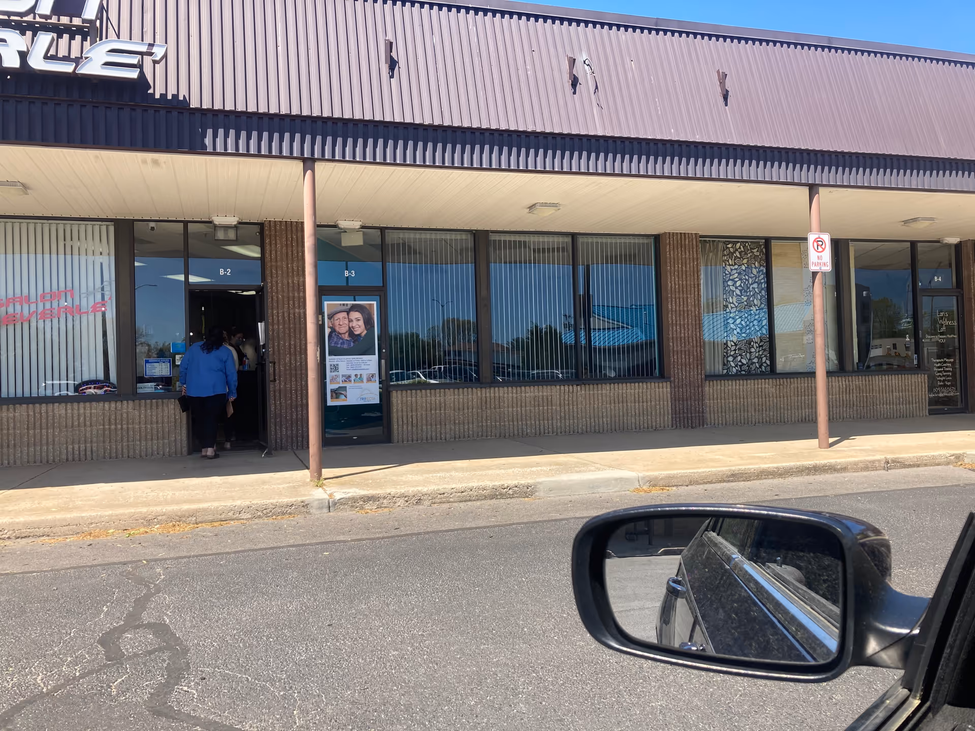 Exterior view of a storefront senior care facility with glass windows and an entrance.