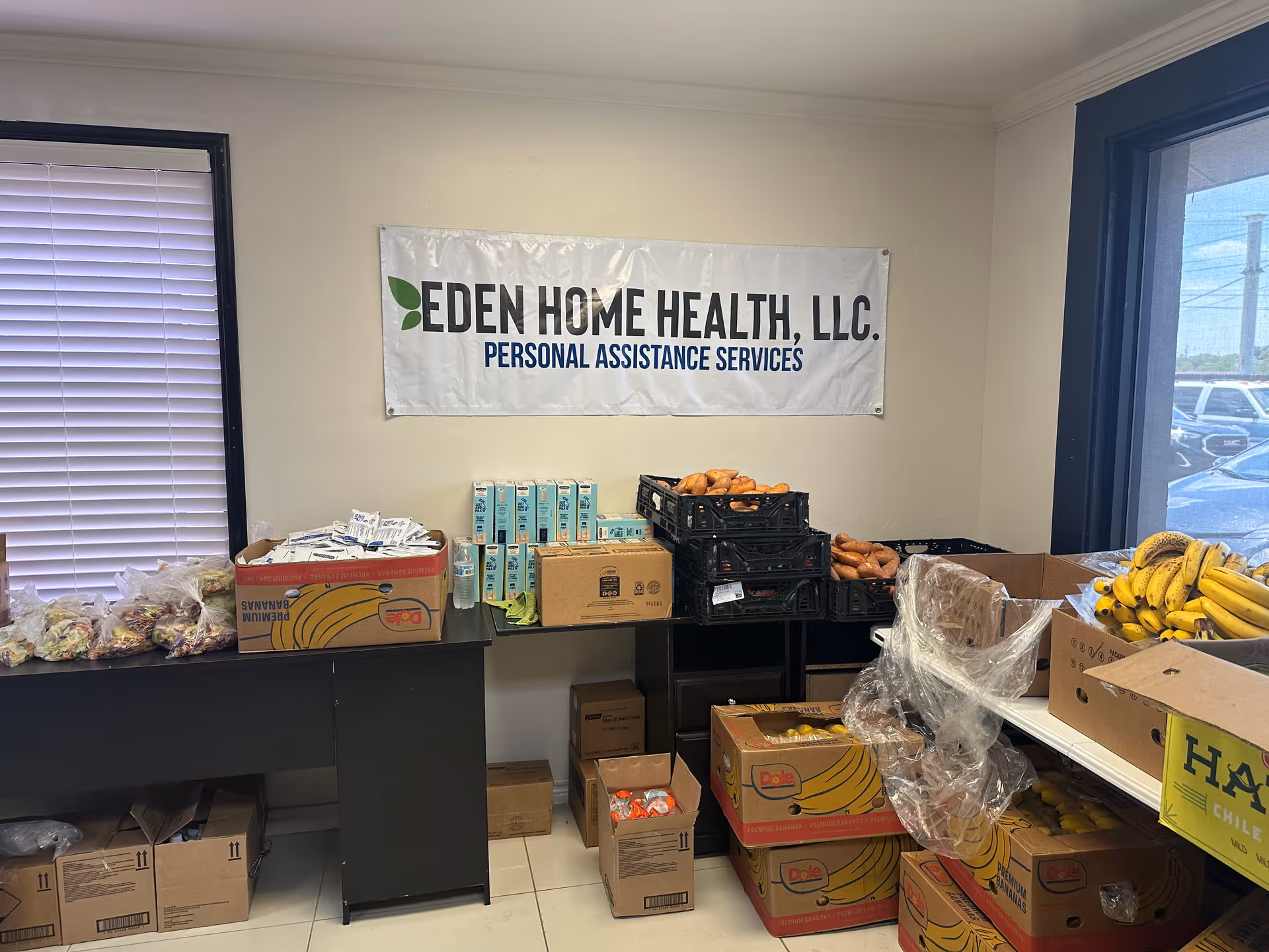 Interior supply area for Eden Home Health with fruit crates, boxes, and a banner.