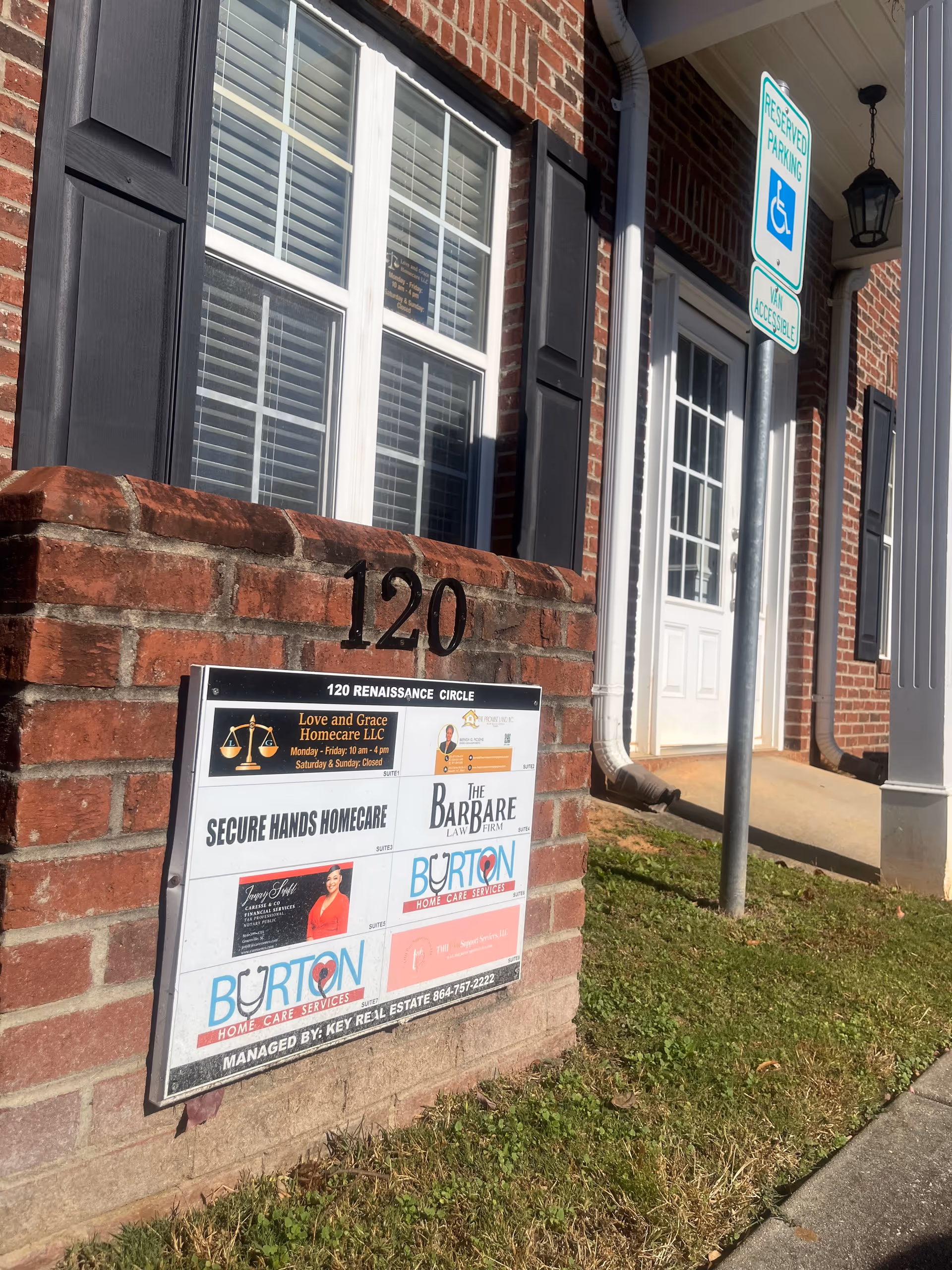 Brick building exterior displaying 120 Renaissance Circle, Burton signs, and a handicap parking sign.