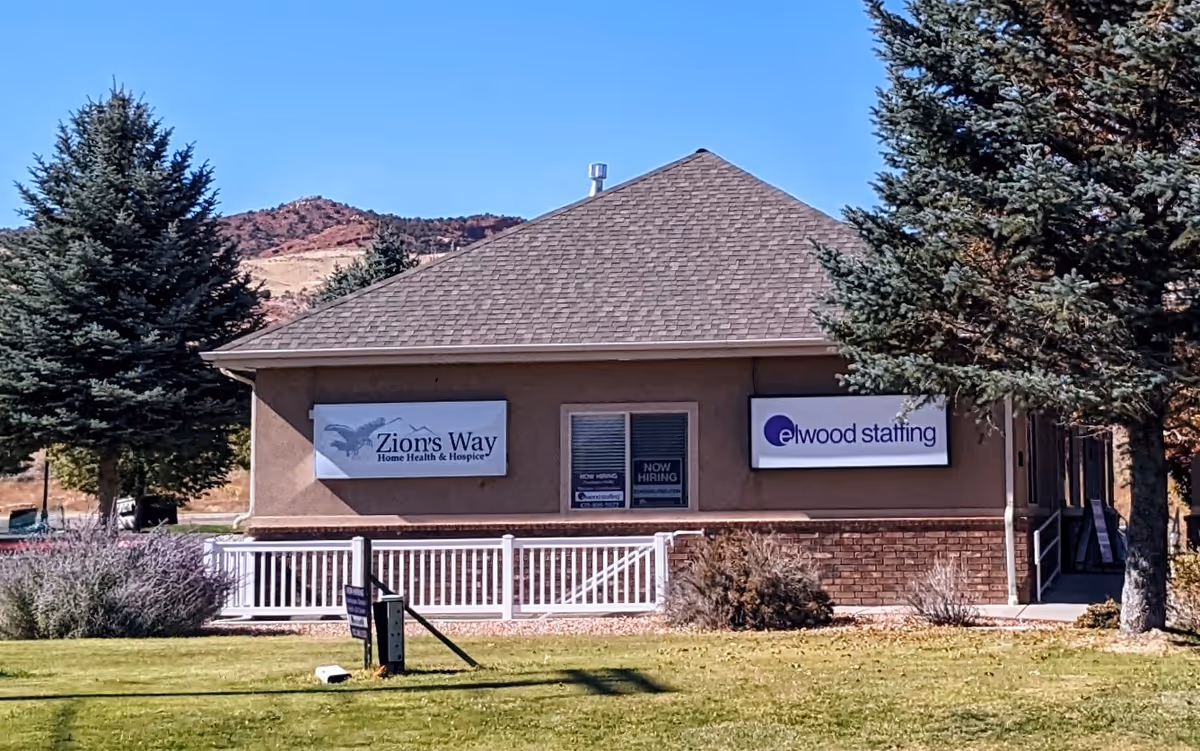 Exterior view of Zion's Way Home Health & Hospice building with staffing signs.