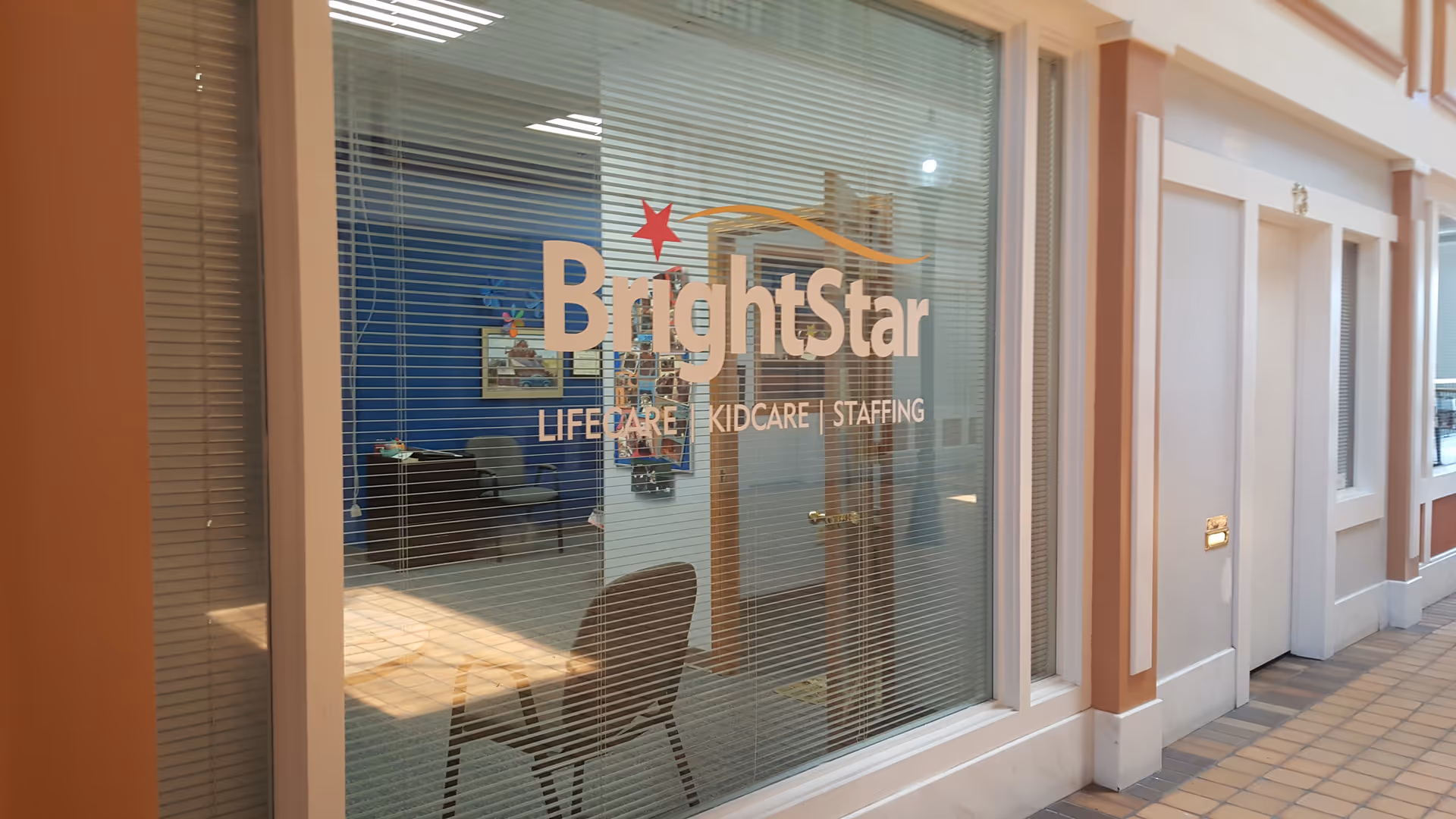 BrightStar Care storefront window with logo and visible interior seating.