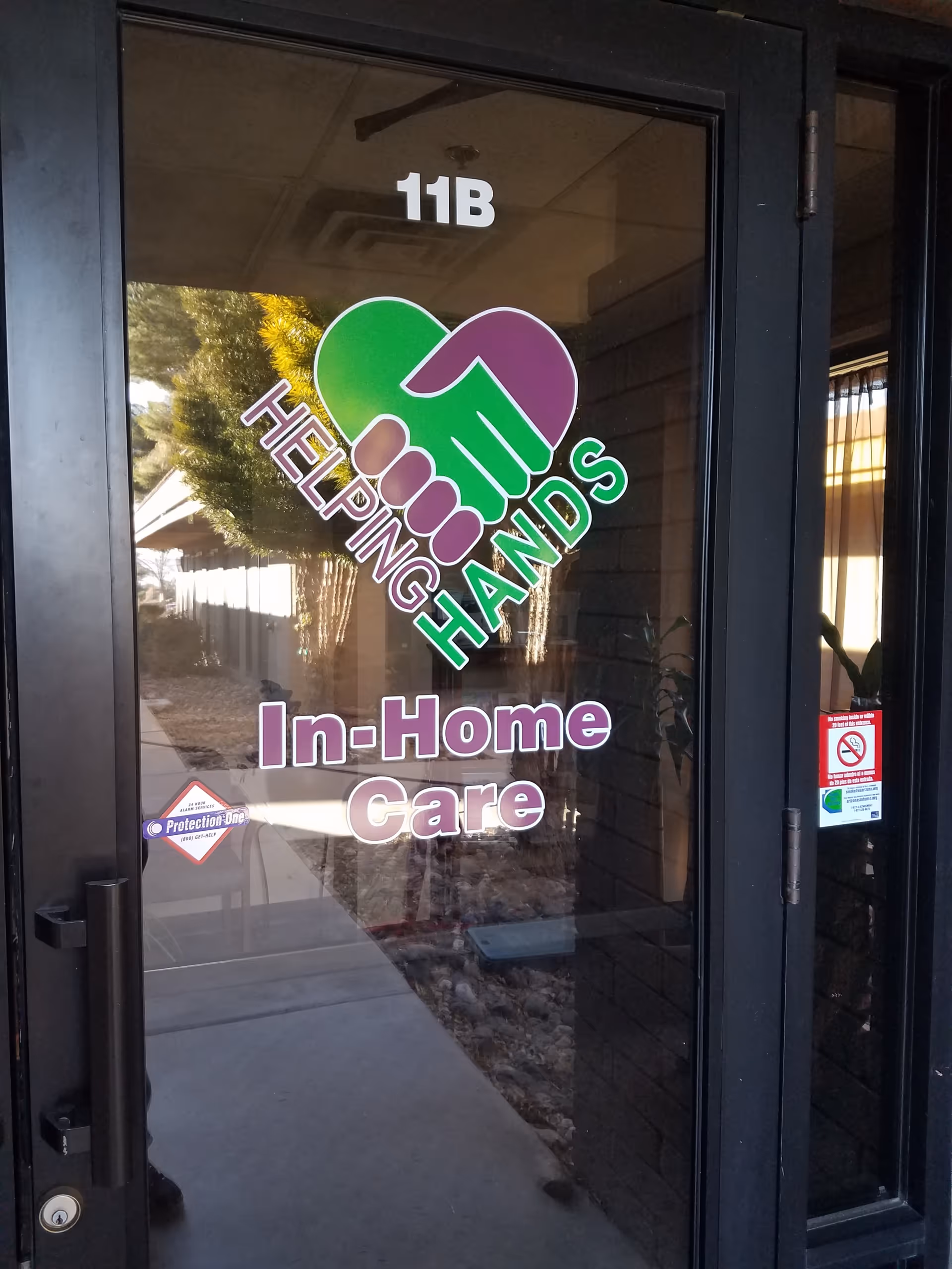 Glass door entrance displaying Helping Hands In-Home Care logo and unit 11B.