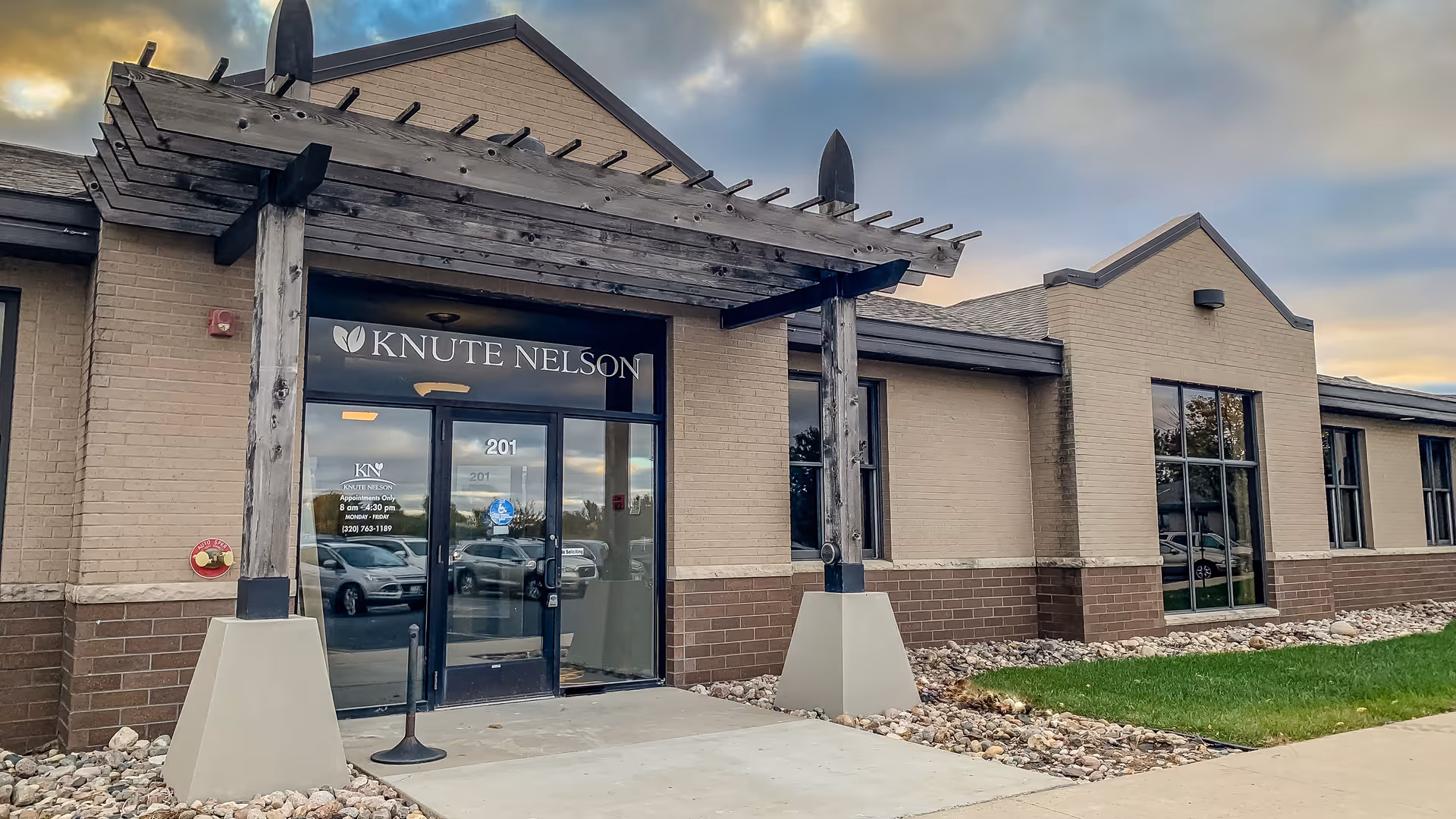 Exterior view of a senior living facility with Knute Nelson signage and glass entrance.