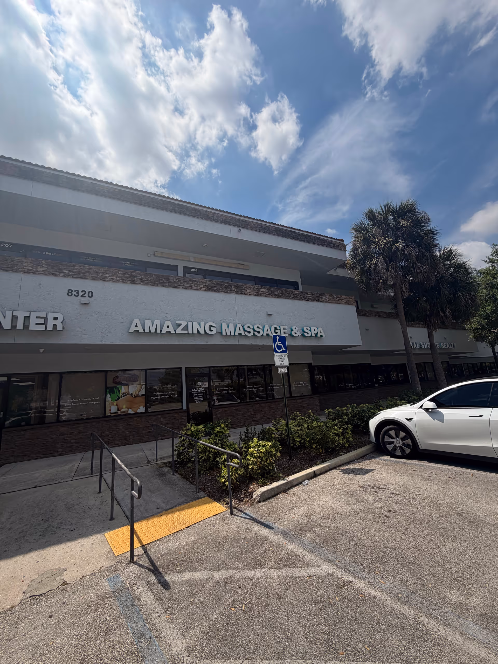 Exterior storefront with Amazing Massage & Spa signage and a wheelchair accessible ramp.