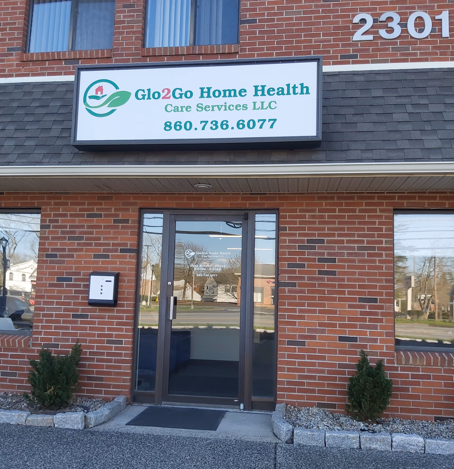 Brick storefront with Glo2Go Home Health Care Services LLC sign above glass doorway.