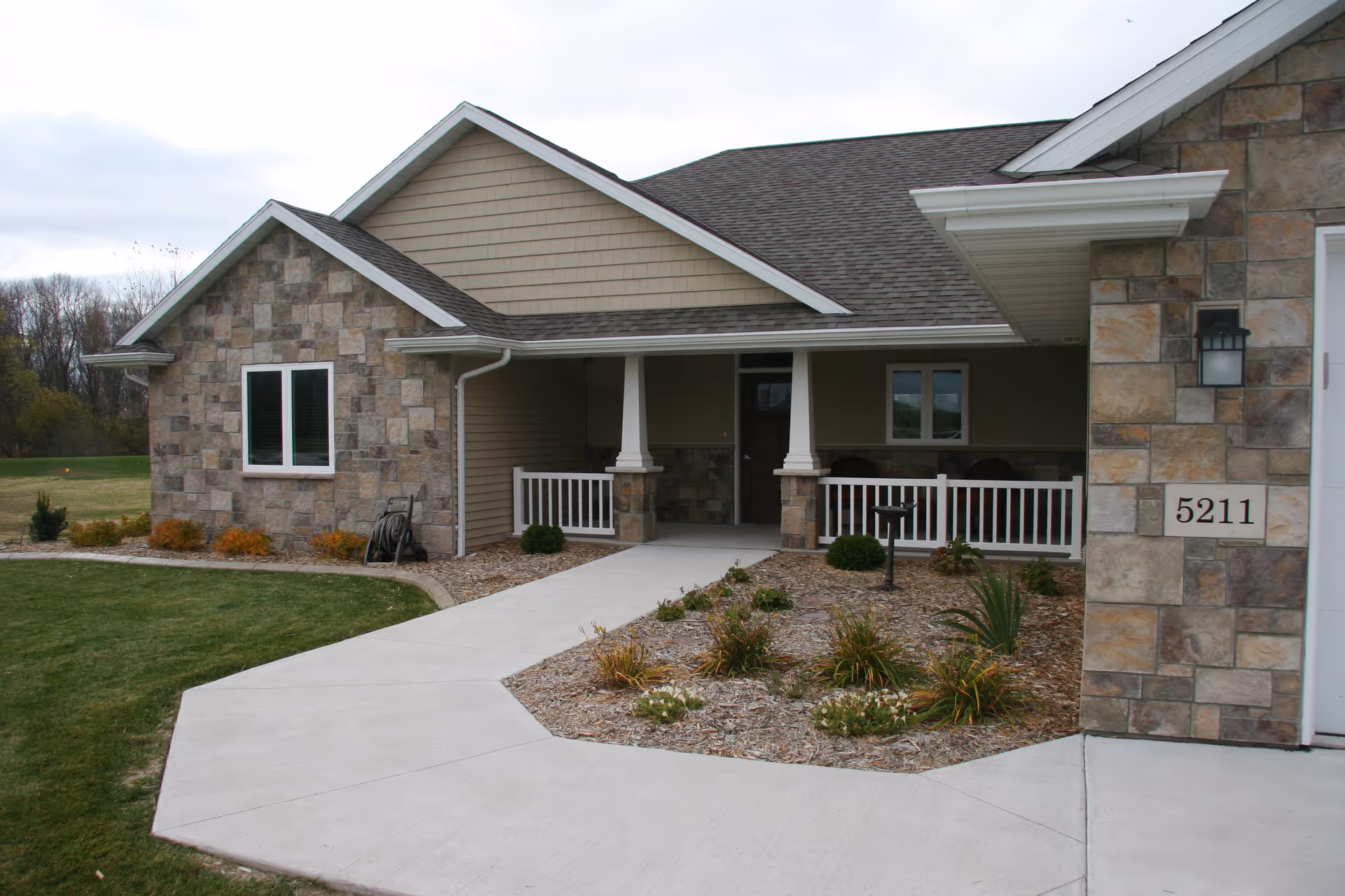 Exterior of a single-story senior living facility with stone accents and a covered front porch.