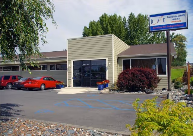 Exterior view of Disability Action Center NW building with parking and handicap spots.